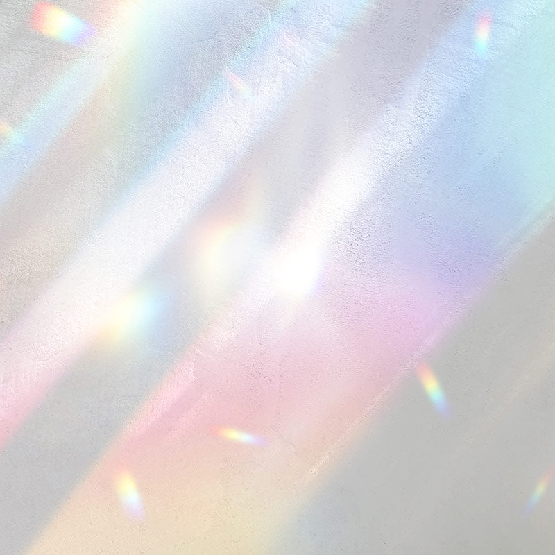 Subtle rainbow light reflections on a neutral surface.
