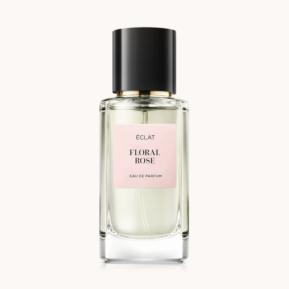 Flacon of the women’s perfume dupe ÉCLAT Floral Rose, an elegant transparent glass bottle with a black cylindrical magnetic cap and a light pink label. The label displays the brand name ÉCLAT, the name Floral Rose, and the phrase “Eau de Parfum”.