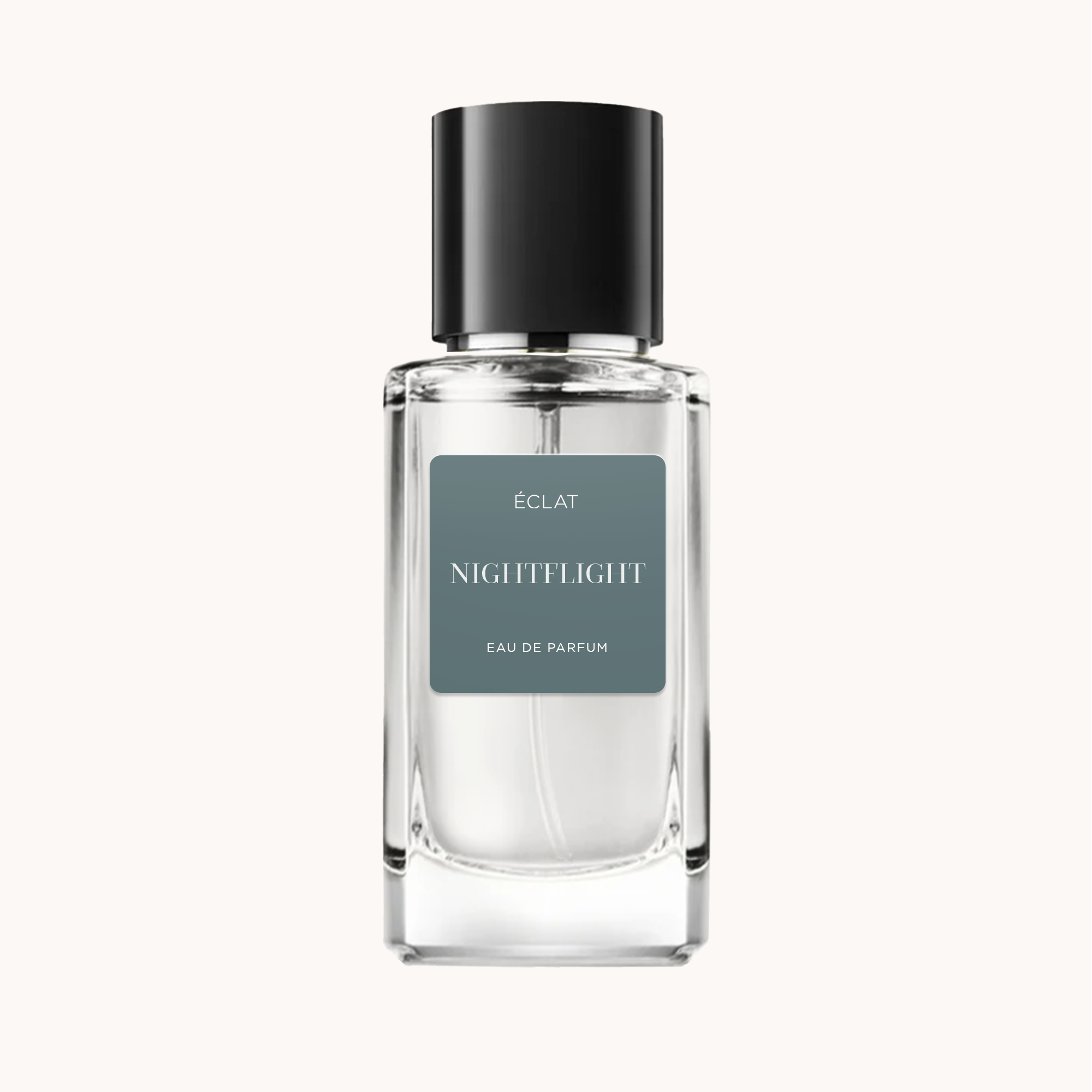 A faceted glass bottle with a matte black cap displays the ÉCLAT Nightflight fragrance. The label is a sleek gray with white text.