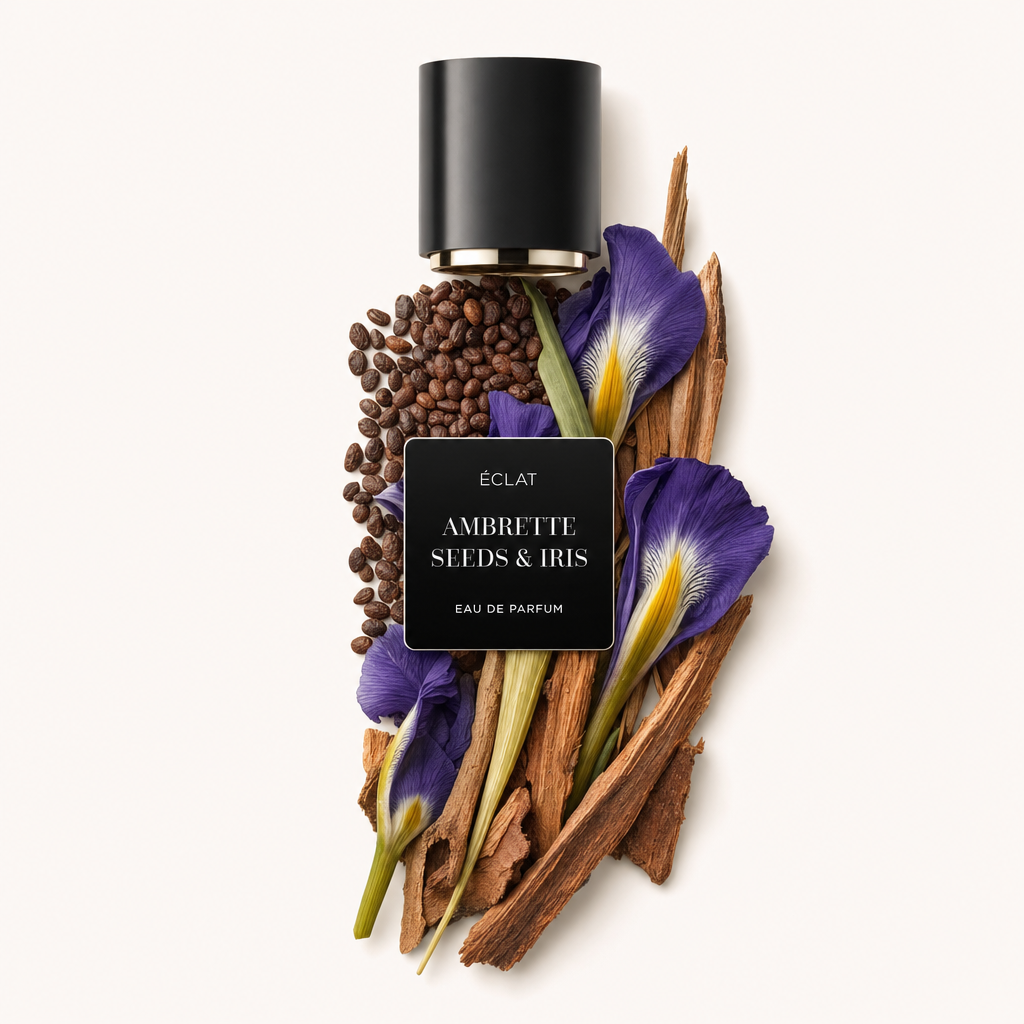 Un arreglo de semillas de ambreta, flores de iris y elementos de madera con una tapa negra etiquetada como 'ÉCLAT Ambrette Seeds & Iris.'