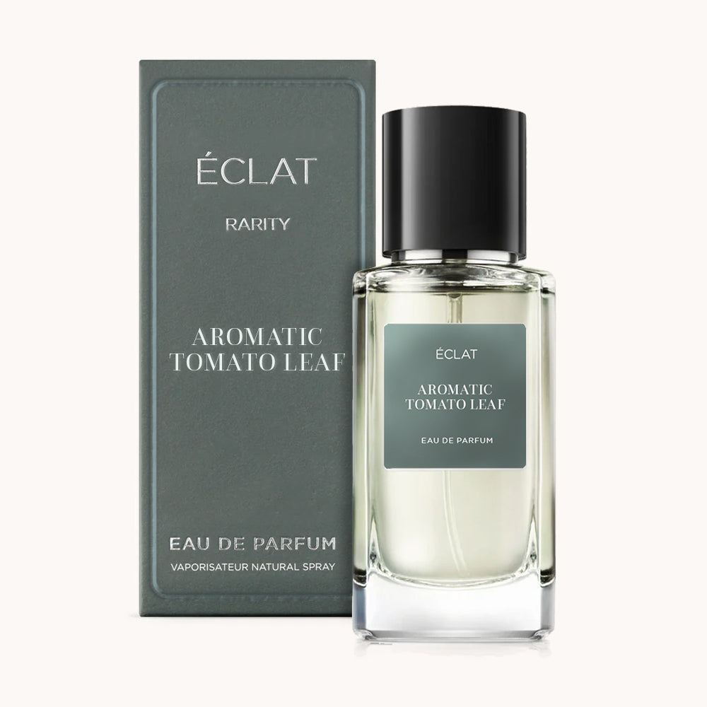 ÉCLAT Aromatic Tomato Leaf perfume bottle with dark green label and black cap, displayed beside matching box.