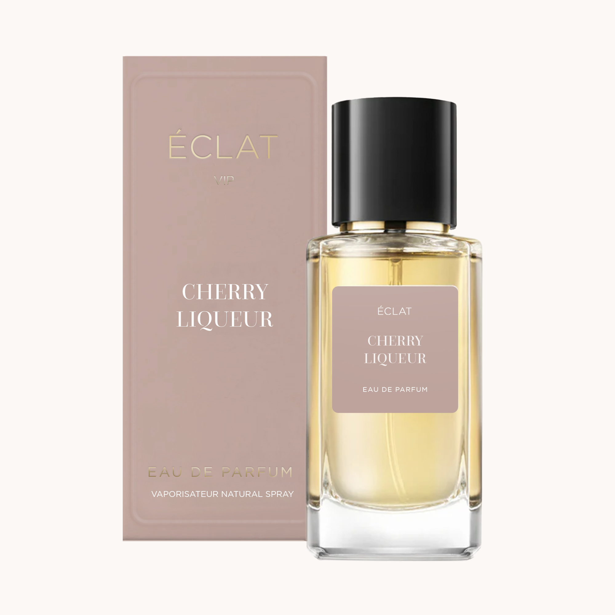 A faceted glass bottle with a black cap containing ÉCLAT Cherry Liqueur fragrance, alongside its matching soft pink box.