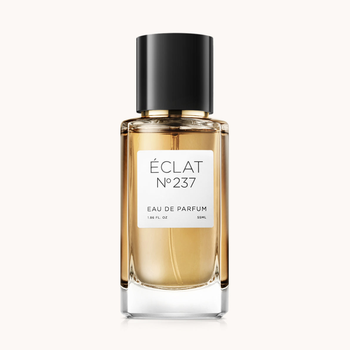 ÉCLAT Iris Butter & Suede en un frasco de vidrio facetado con tapa negra y etiqueta blanca.