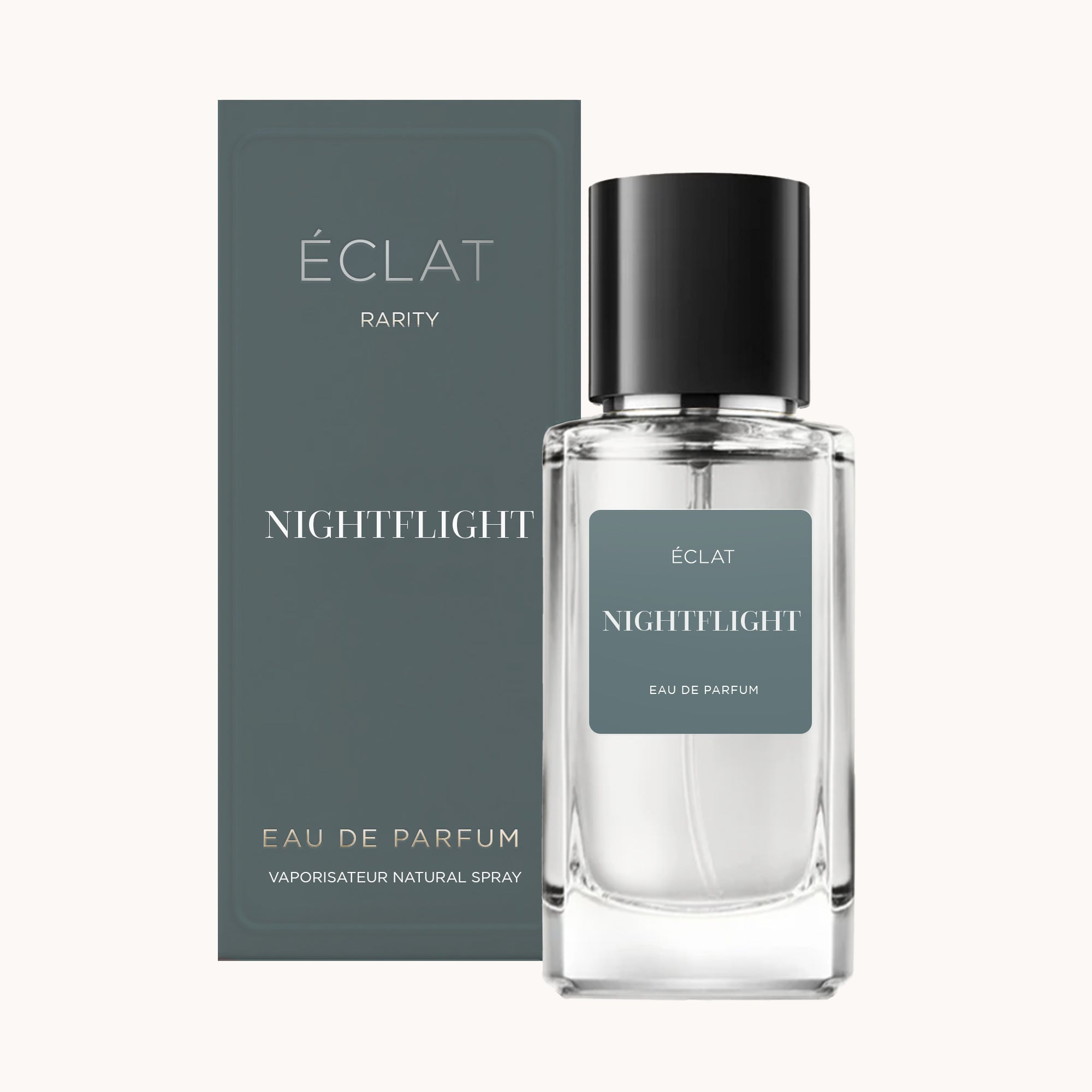 The ÉCLAT Nightflight fragrance features a clear glass bottle with a sleek black cap, paired with an elegant dark gray box.