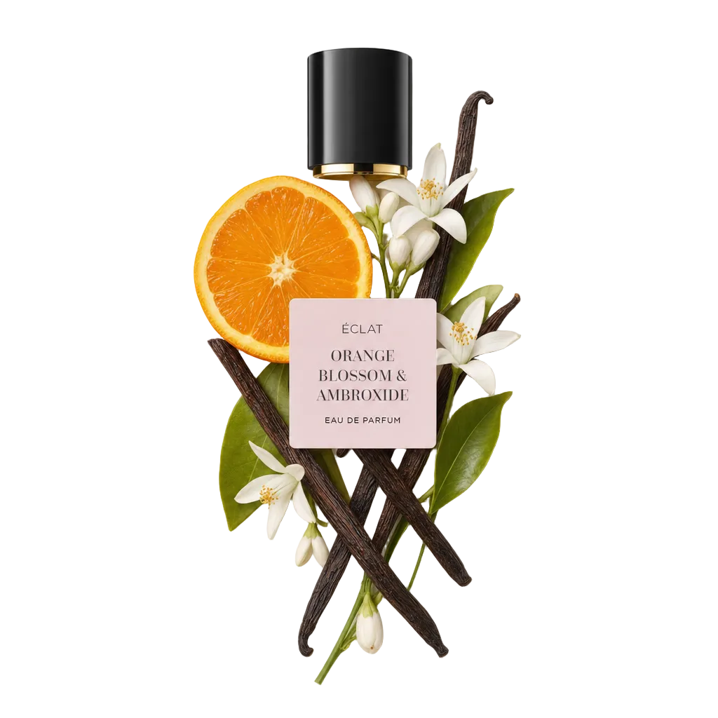 A harmonious arrangement of vanilla pods, orange slices, and orange blossoms with lush green leaves below a black cap embossed with ÉCLAT Orange Blossom & Ambroxide label.
