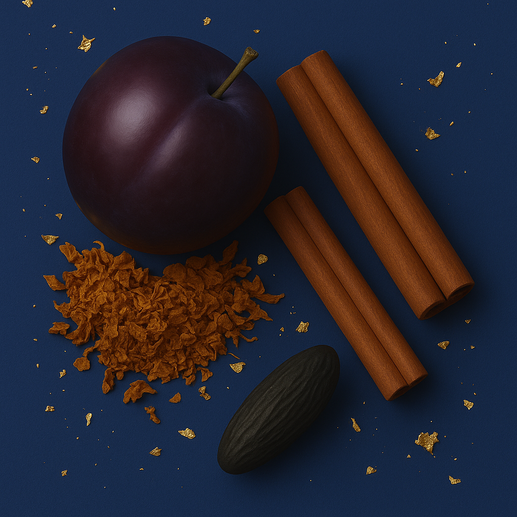 Un arrangement de prune mûre, bâtons de cannelle, fève tonka et flocons de tabac sur un fond bleu foncé.