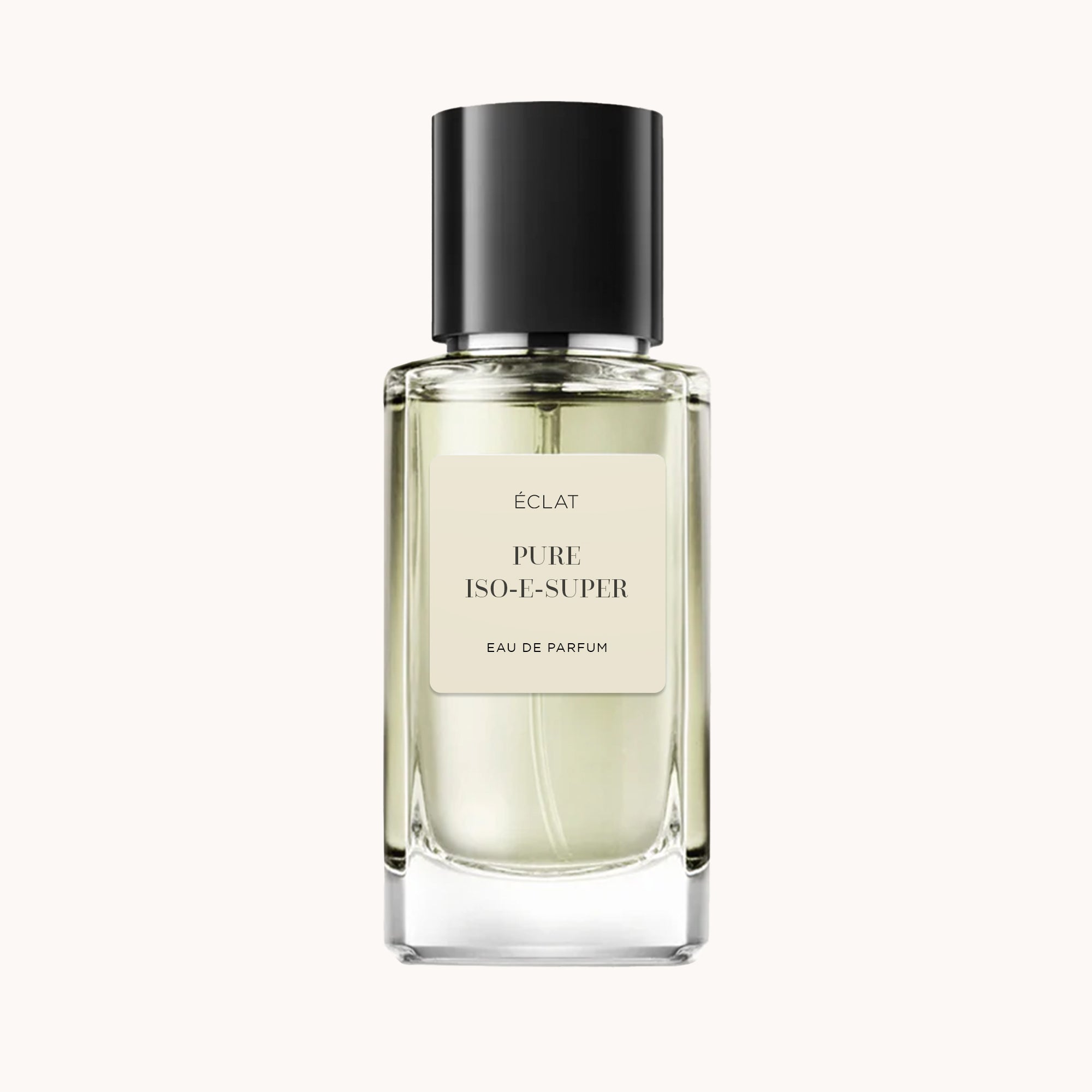 The ÉCLAT Pure Iso-E-Super perfume bottle features a clear, faceted glass design with a matte black cap and a minimalist label.