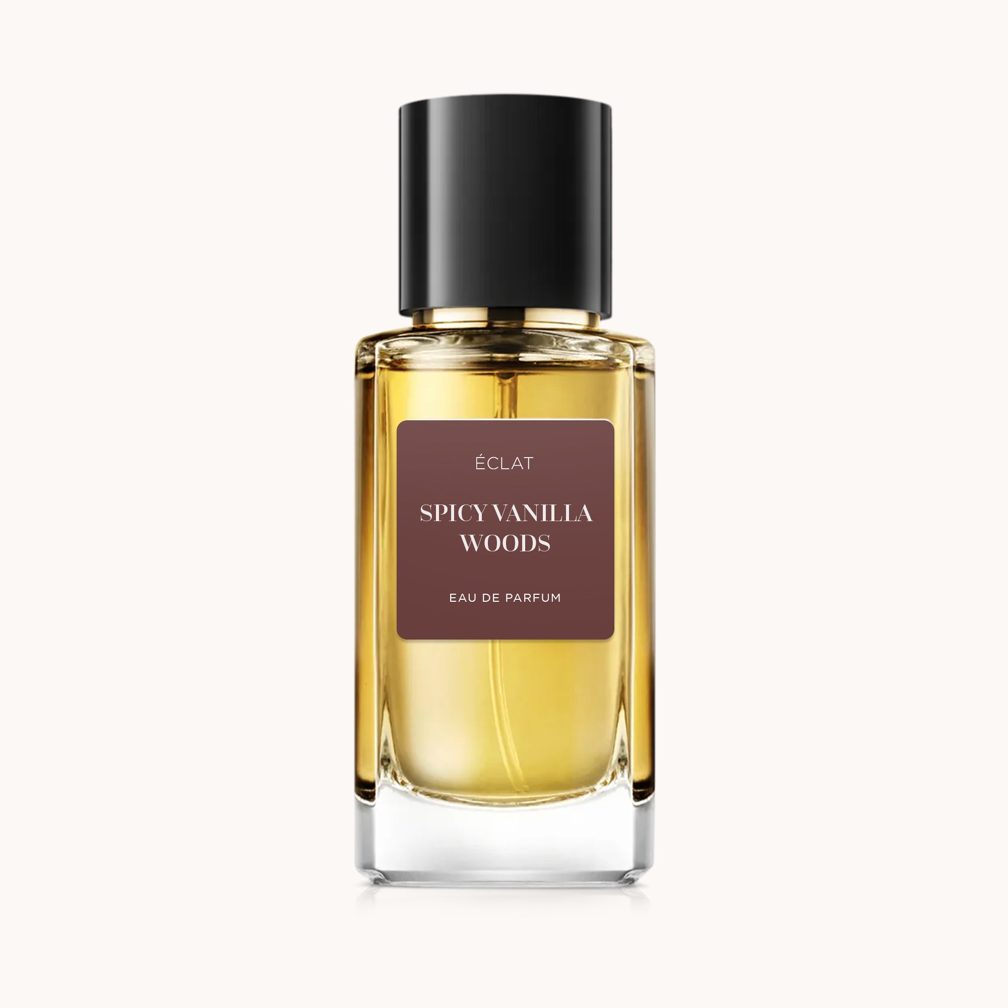 ÉCLAT Spicy Vanilla Woods in a clear glass bottle with a black cap and brown label.