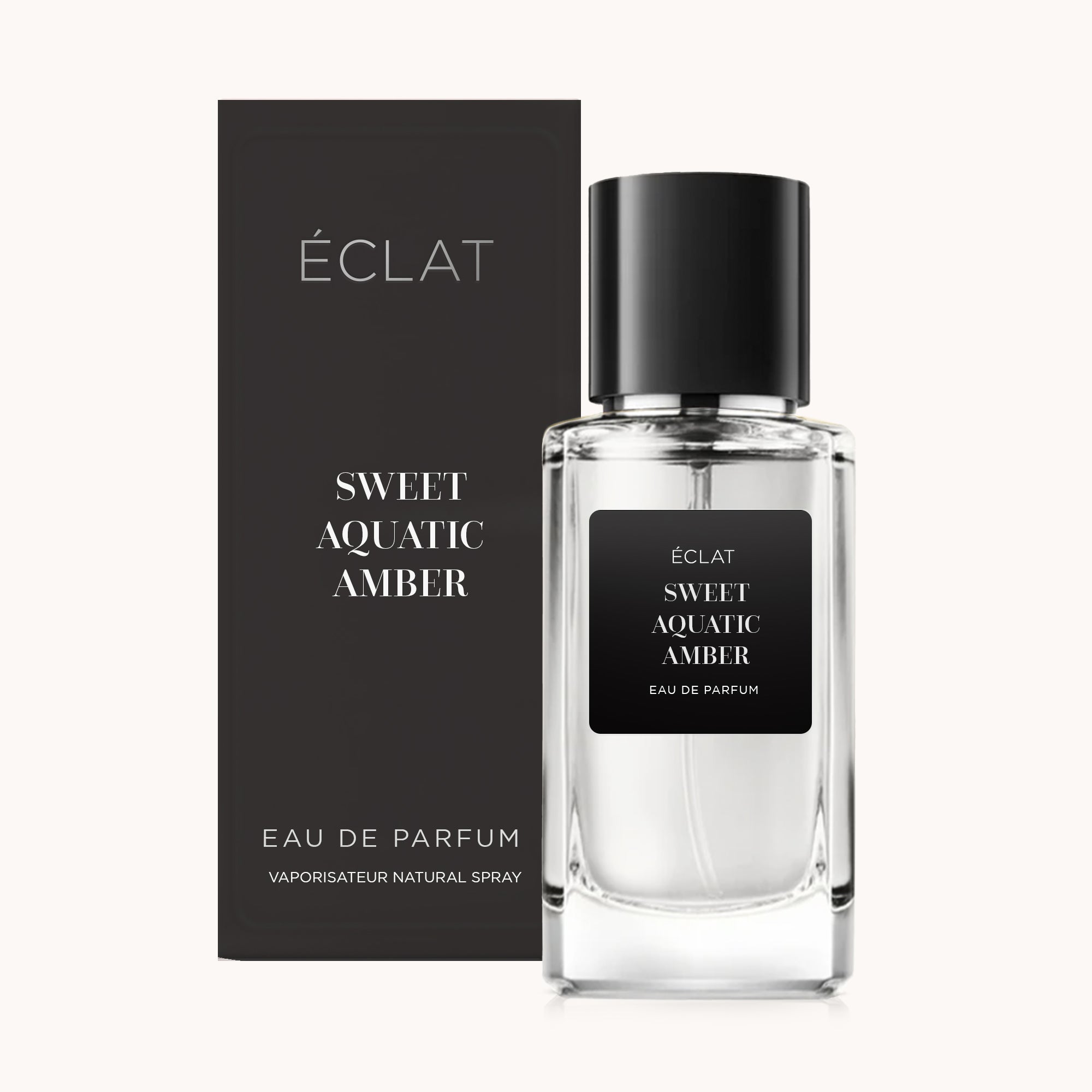 Um frasco de vidro facetado de ÉCLAT Sweet Aquatic Amber com etiqueta e tampa pretas, ao lado de uma caixa de apresentação preta correspondente.
