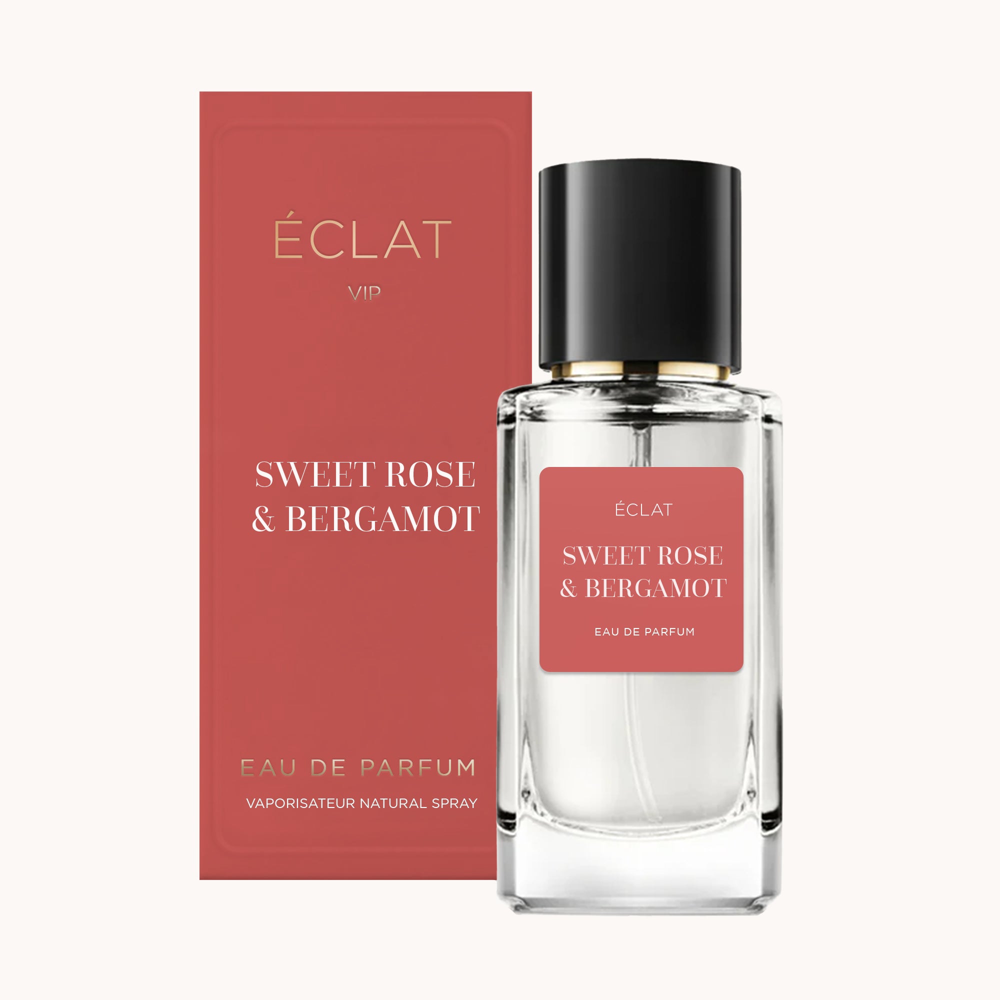 Faceted glass bottle of ÉCLAT Sweet Rose & Bergamot with a black cap, alongside a matching rose-colored box.