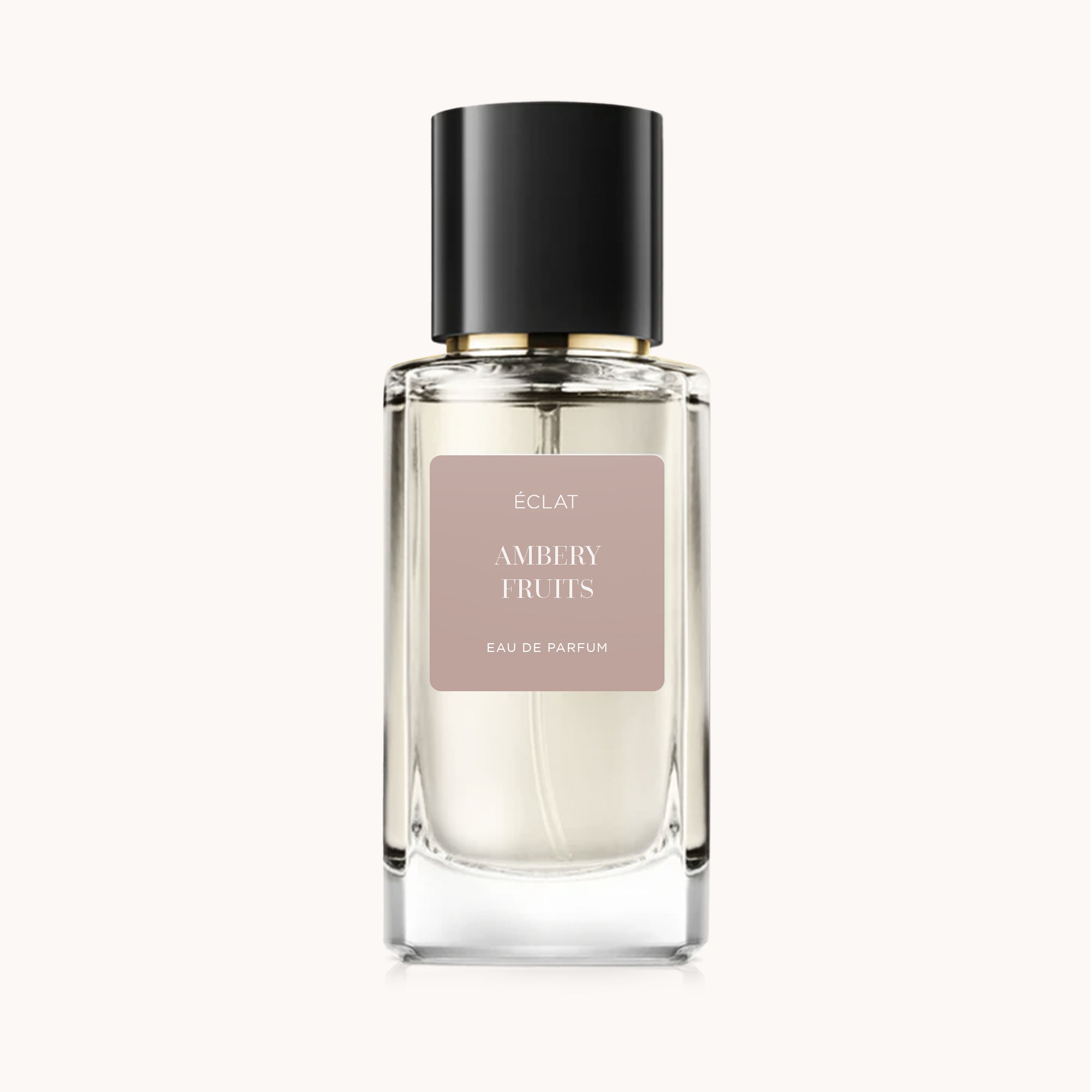 The faceted glass bottle of ÉCLAT Ambery Fruits with a black cap and matte label is elegantly displayed.