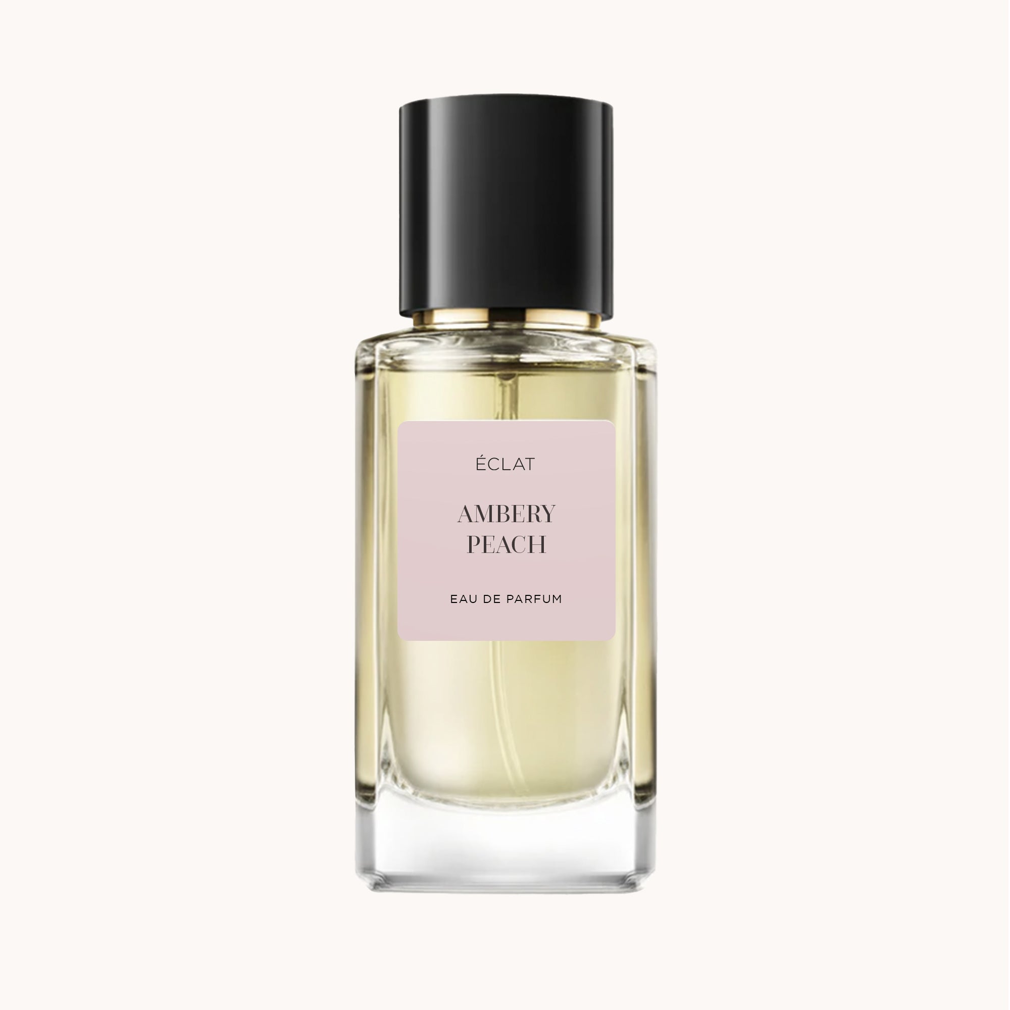 Clear glass bottle of ÉCLAT Ambery Peach with a black cap.