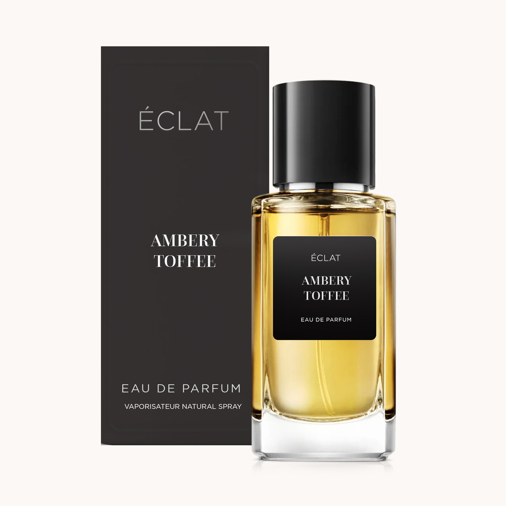 Frasco de fragrância ÉCLAT Ambery Toffee com rótulo e tampa pretos, junto a uma caixa preta correspondente.