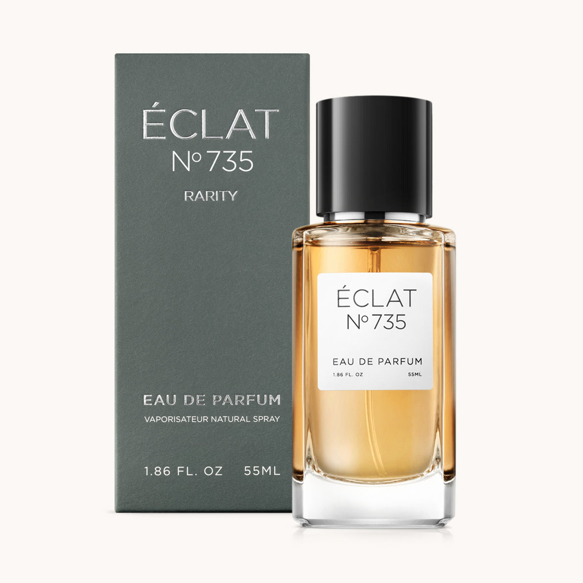 ÉCLAT Ambery Woods perfume with a faceted glass bottle and black cap, displayed with its elegant grey box.