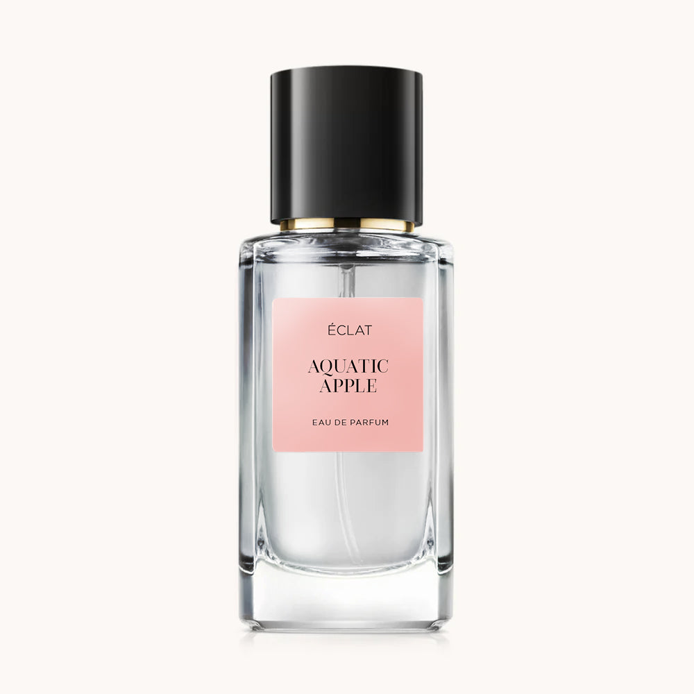 Transparent glass bottle with a black cap and a pale pink label featuring ÉCLAT Aquatic Apple.