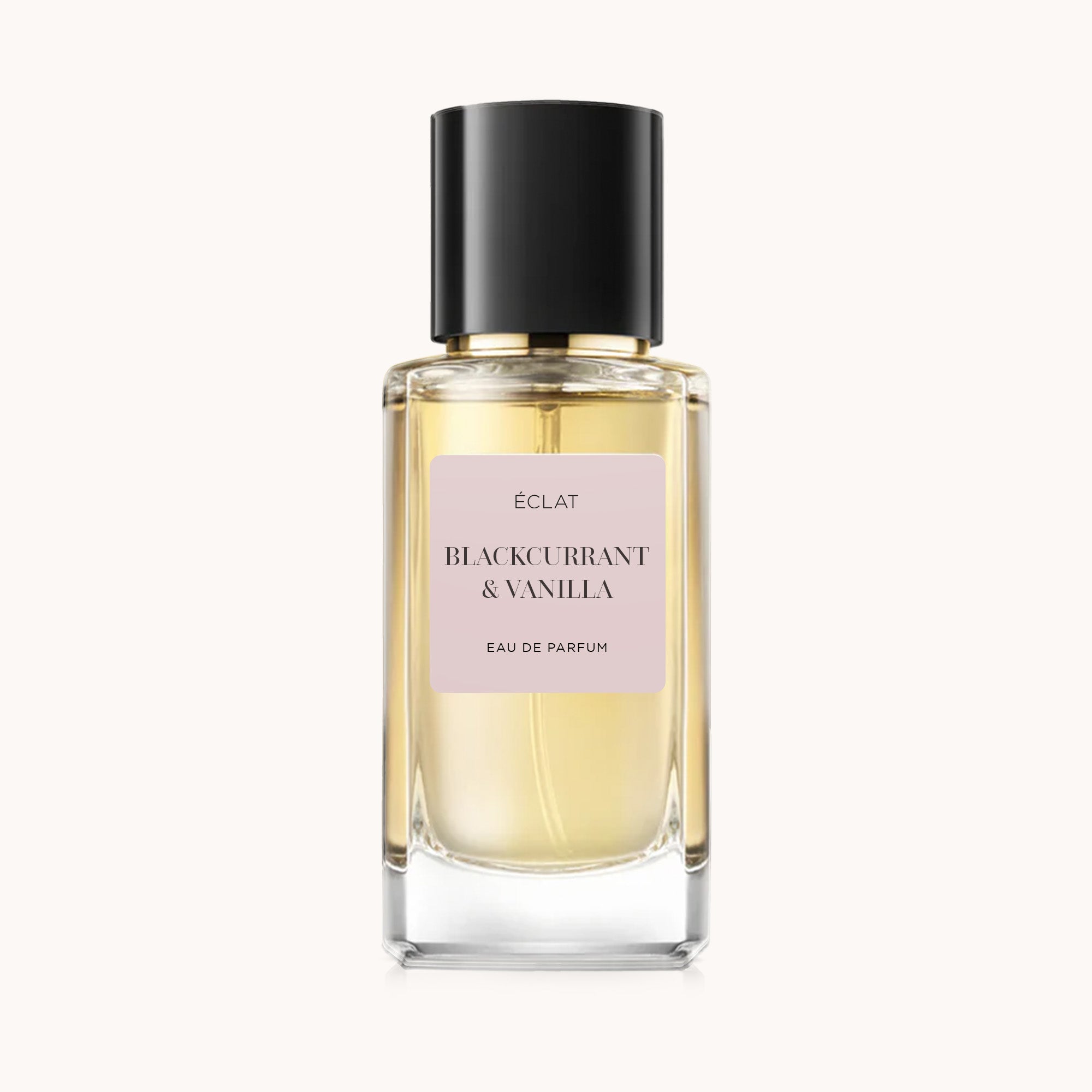 Frasco de vidrio facetado de ÉCLAT Blackcurrant & Vanilla con etiqueta rosa pálido y tapa negra.