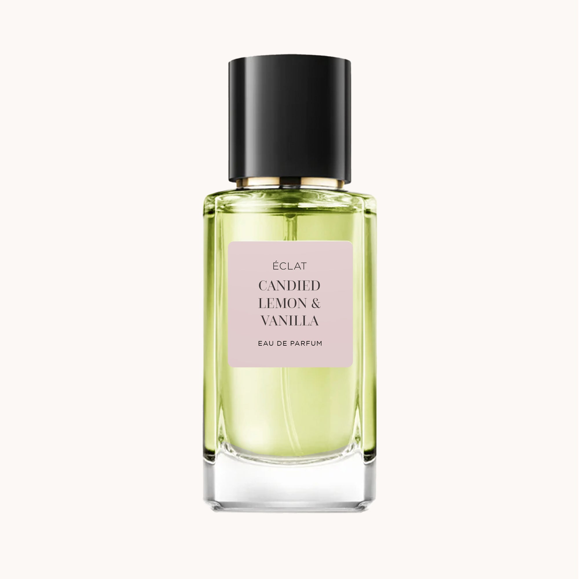 Faceted glass bottle of ÉCLAT Candied Lemon & Vanilla with a pale pink label and a sleek black cap.