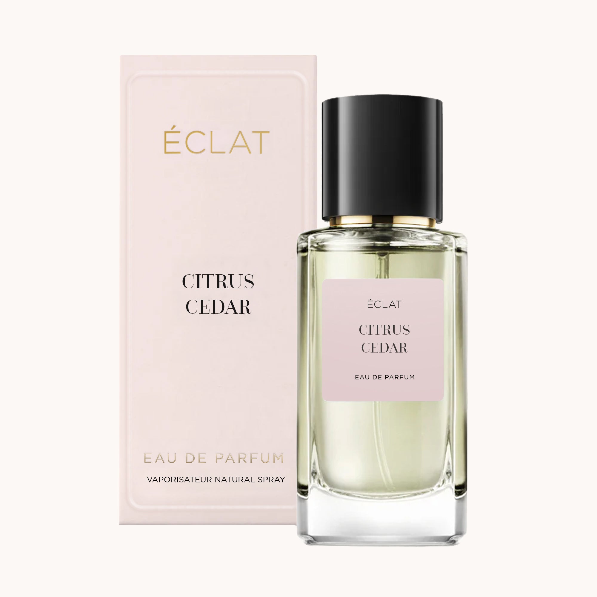 A clear glass bottle with a black cap and a light pink label reading 'ÉCLAT Citrus Cedar', placed next to its elegant light pink box.