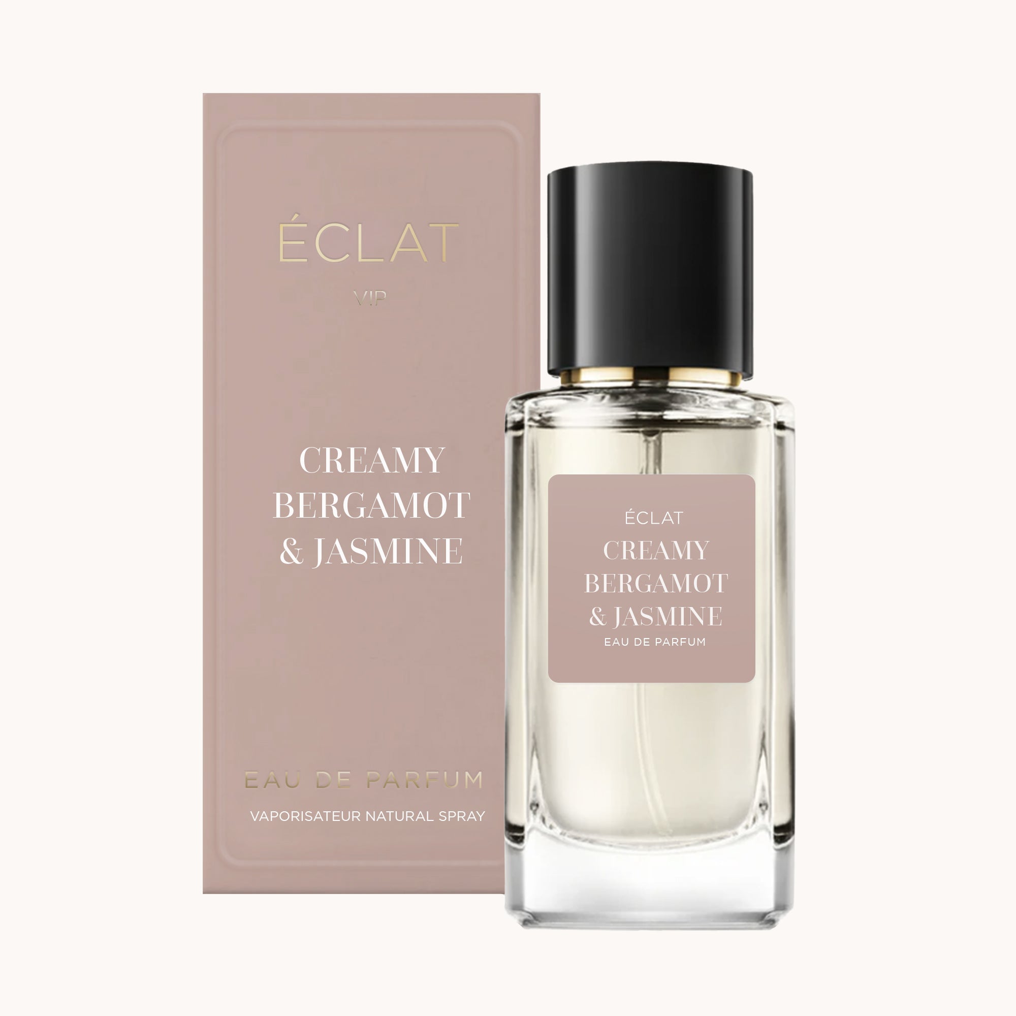 ÉCLAT Creamy Bergamot & Jasmine perfume bottle with a transparent faceted design and a black cap, next to a matching blush-toned box.