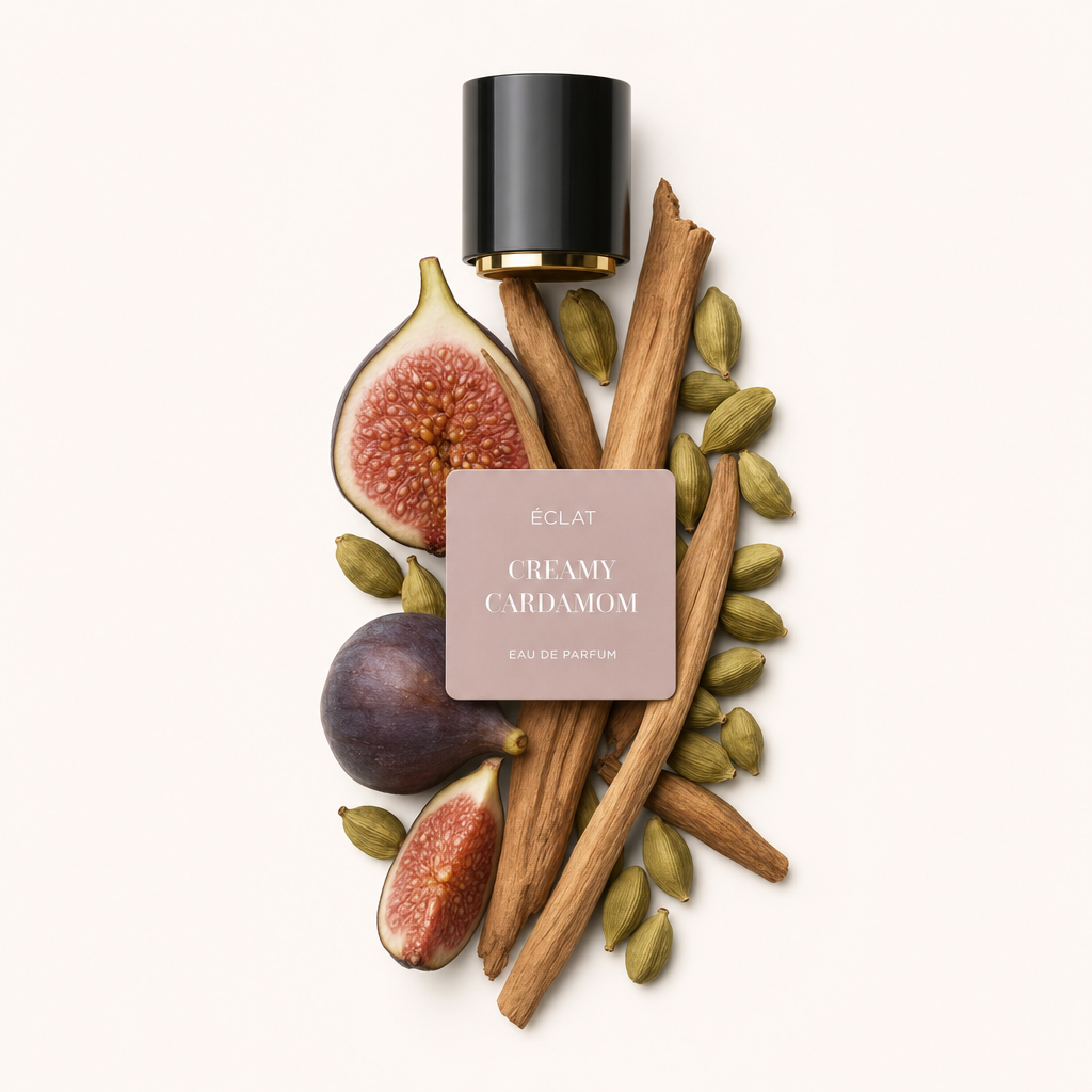 A composition of fresh figs, cinnamon sticks, and cardamom pods surrounds the original black cap with label of ÉCLAT Creamy Cardamom.