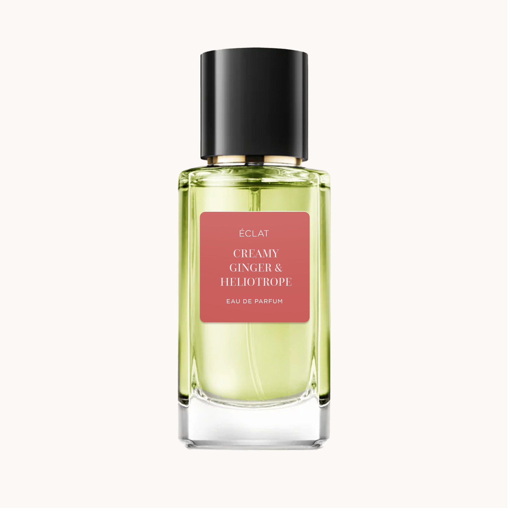 Un flacon en verre facetté d'ÉCLAT Creamy Ginger & Heliotrope avec un capuchon noir et une étiquette rose.