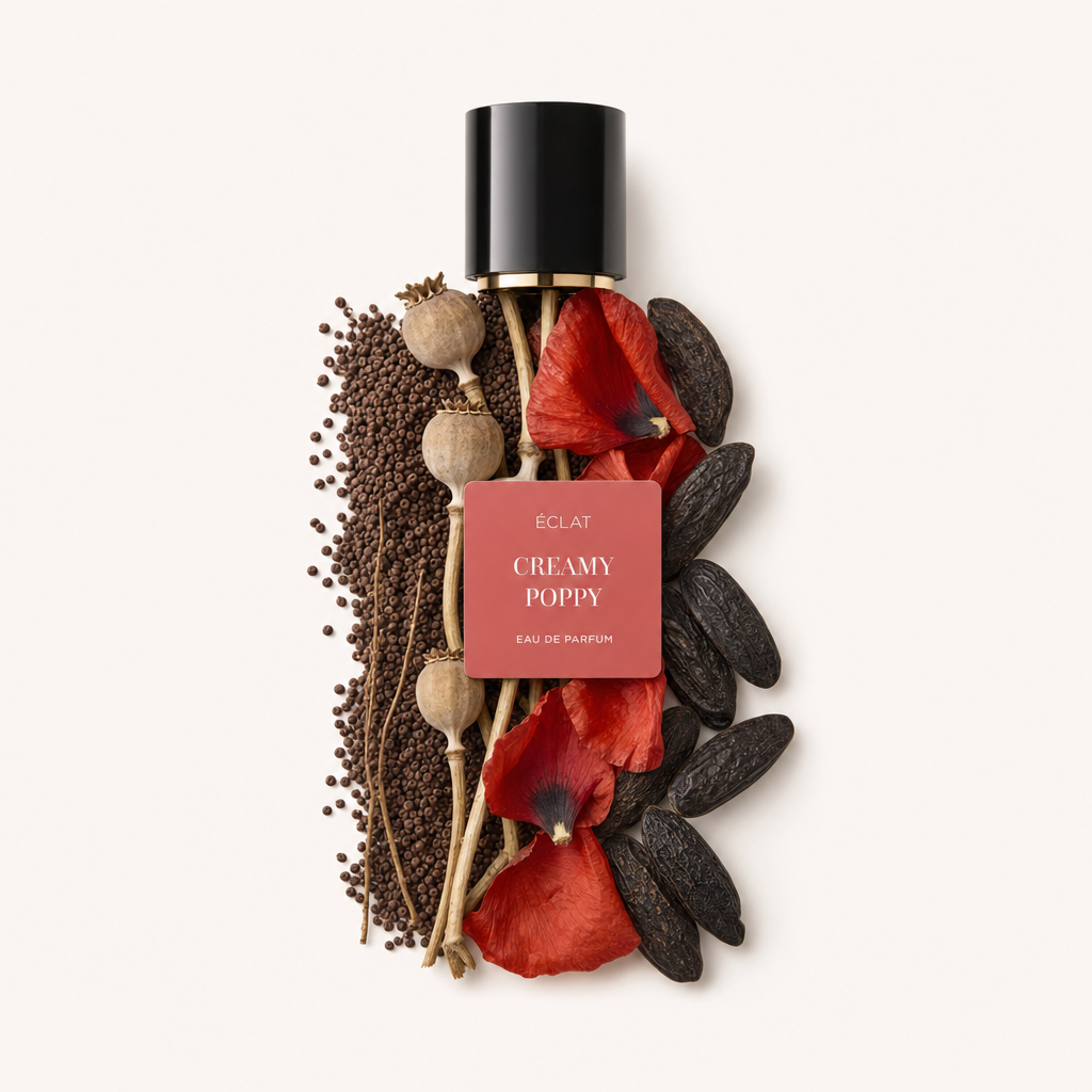 A black cap with a label atop an artful arrangement of poppy petals, vanilla pods, and seeds. The label reads ÉCLAT Creamy Poppy.