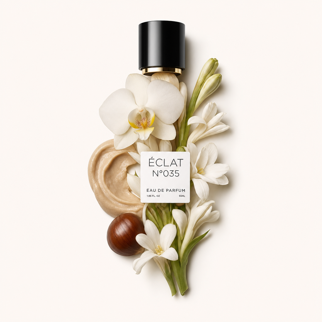 Uma composição de textura cremosa, flores de tuberosa brancas e uma orquídea envolve uma tampa preta com rótulo para ÉCLAT Creamy Tuberose.