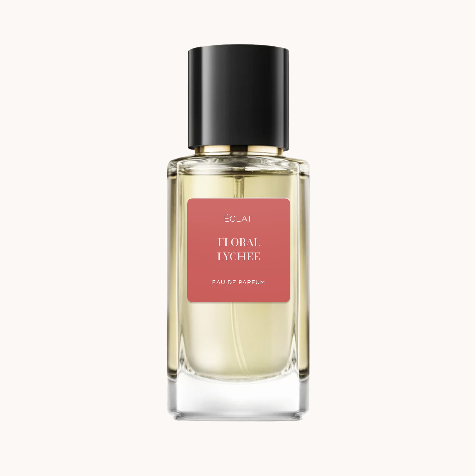 Flacon en verre facetté avec bouchon noir, étiquette mate en rose chaud avec le nom ÉCLAT Floral Lychee.