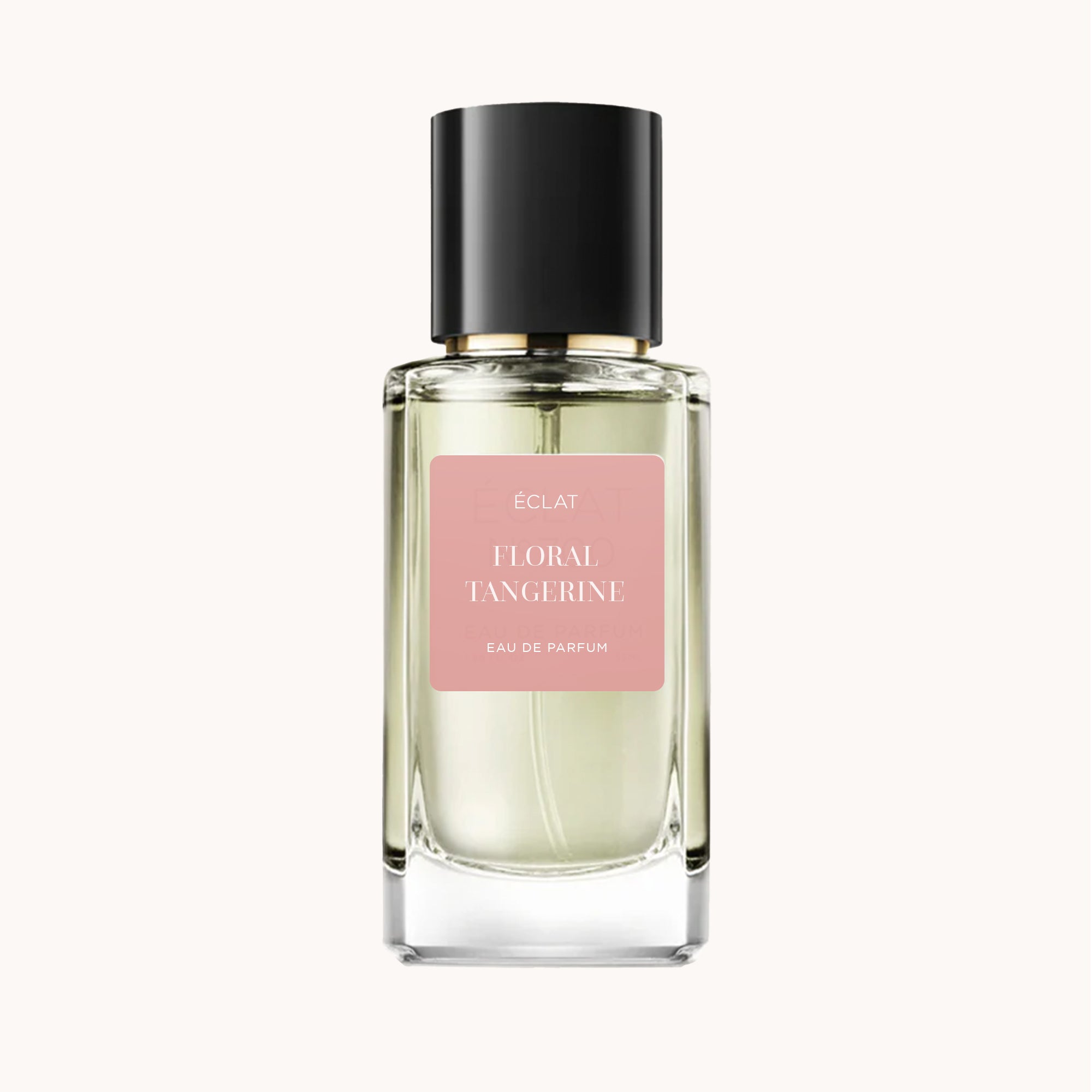 ÉCLAT Floral Tangerine is showcased in a faceted glass flacon with a sleek black cap and a soft pink label.