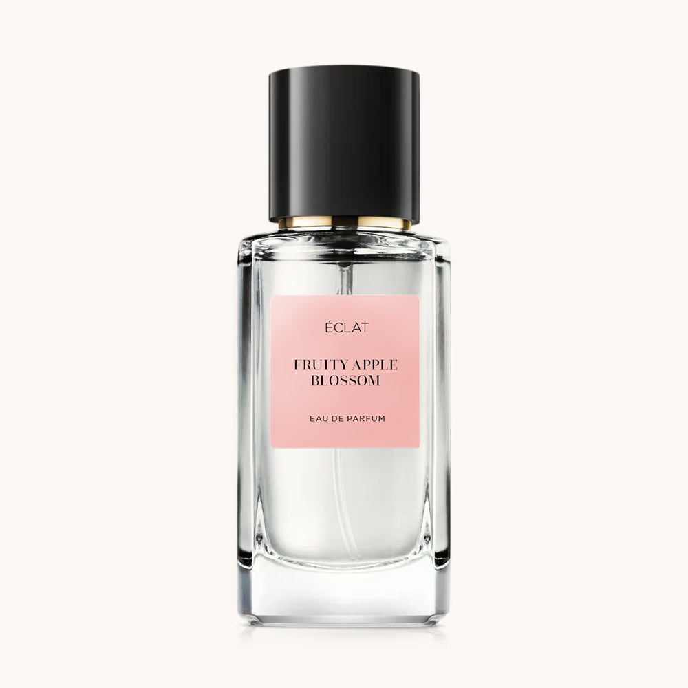ÉCLAT Fruity Apple Blossom fragrance in a faceted glass bottle with a black cap and a pink label.