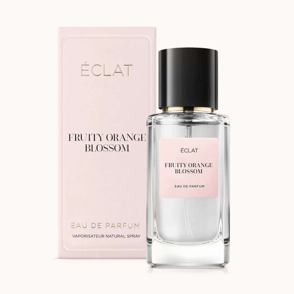 ÉCLAT Fruity Orange Blossom perfume bottle with transparent glass and black cap, alongside a pink box displaying the product name.