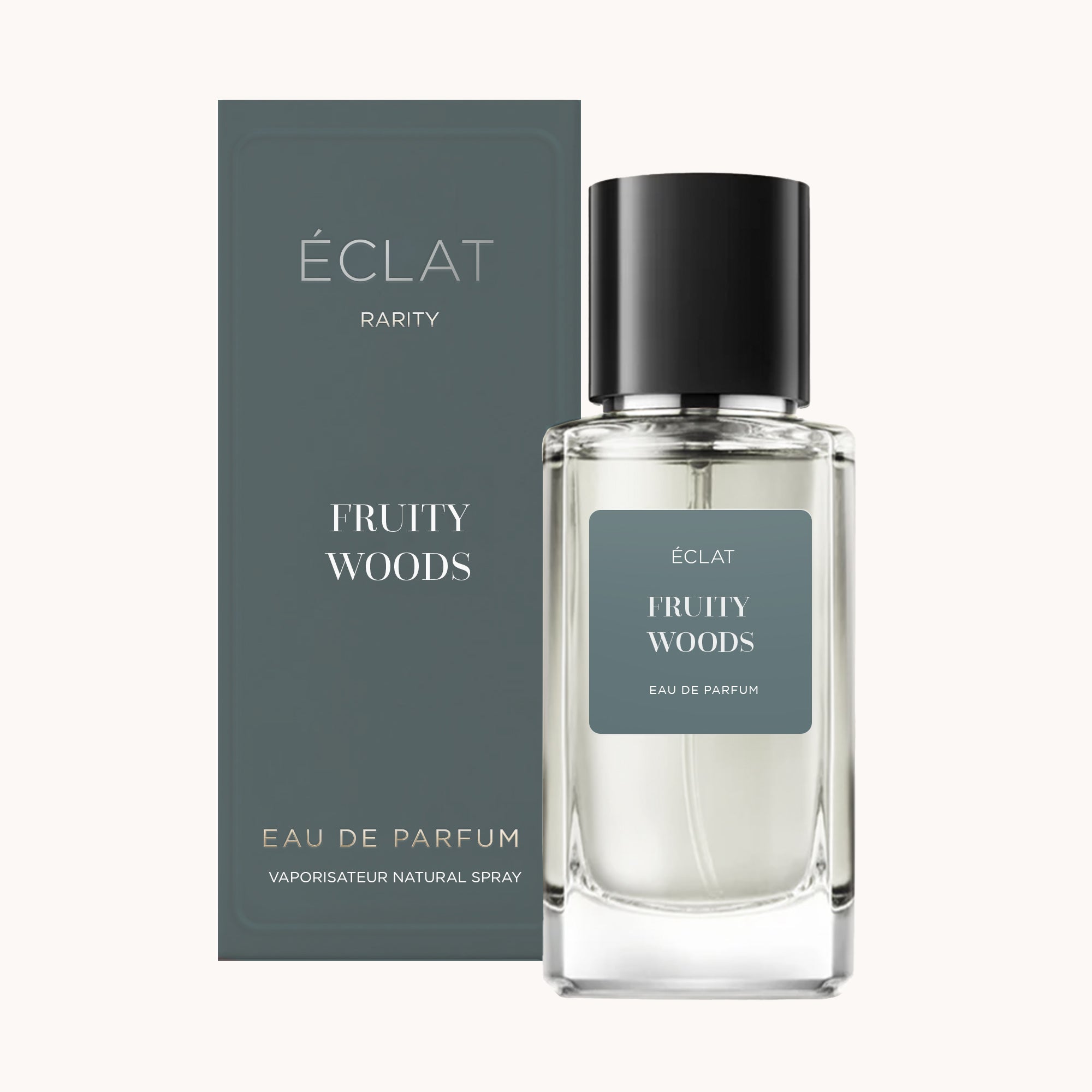 Frasco de fragancia ÉCLAT Fruity Woods junto a su elegante empaque verde oscuro.