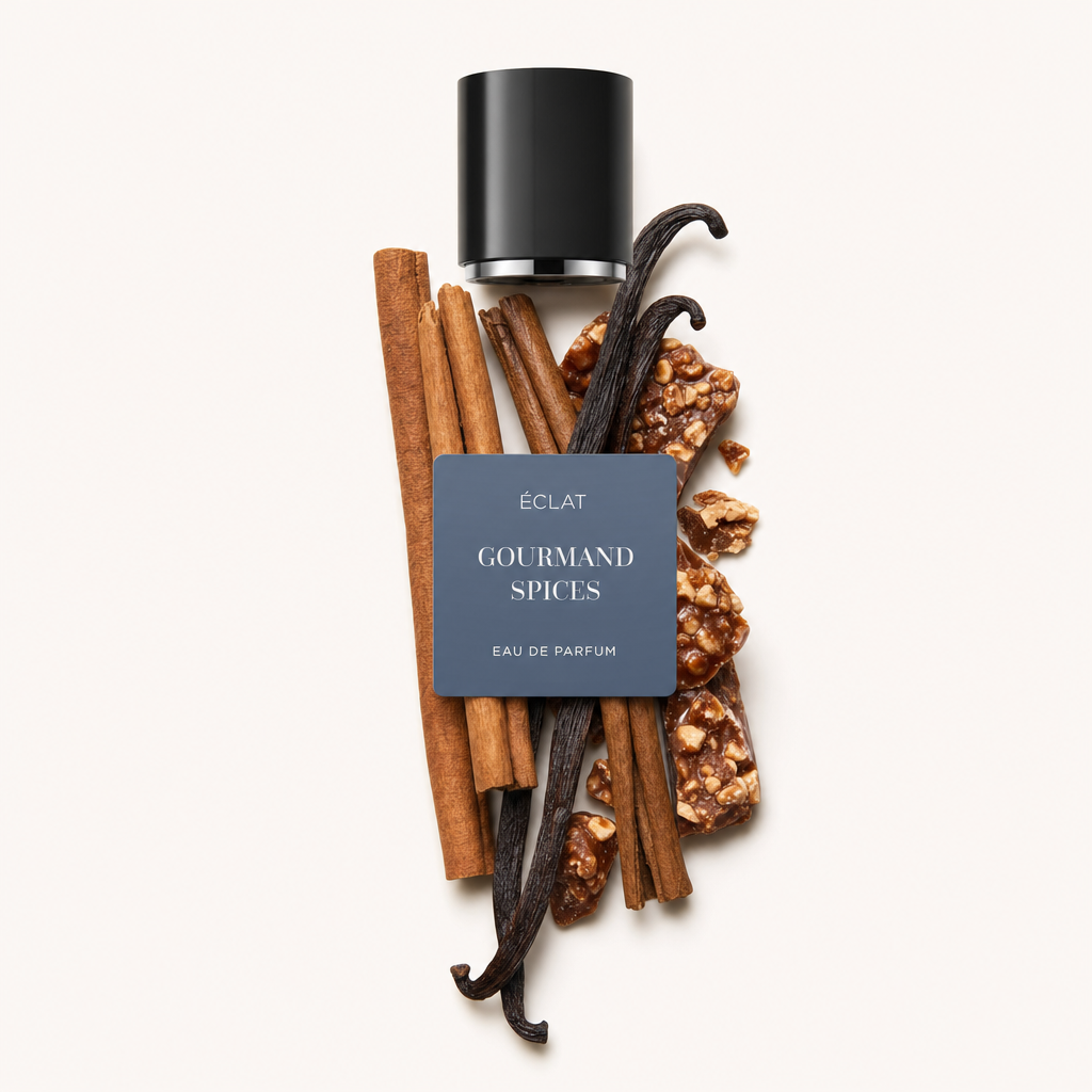 Un arrangement de gousses de vanille, bâtons de cannelle et morceaux de caramel avec un bouchon noir étiqueté ÉCLAT Gourmand Spices.