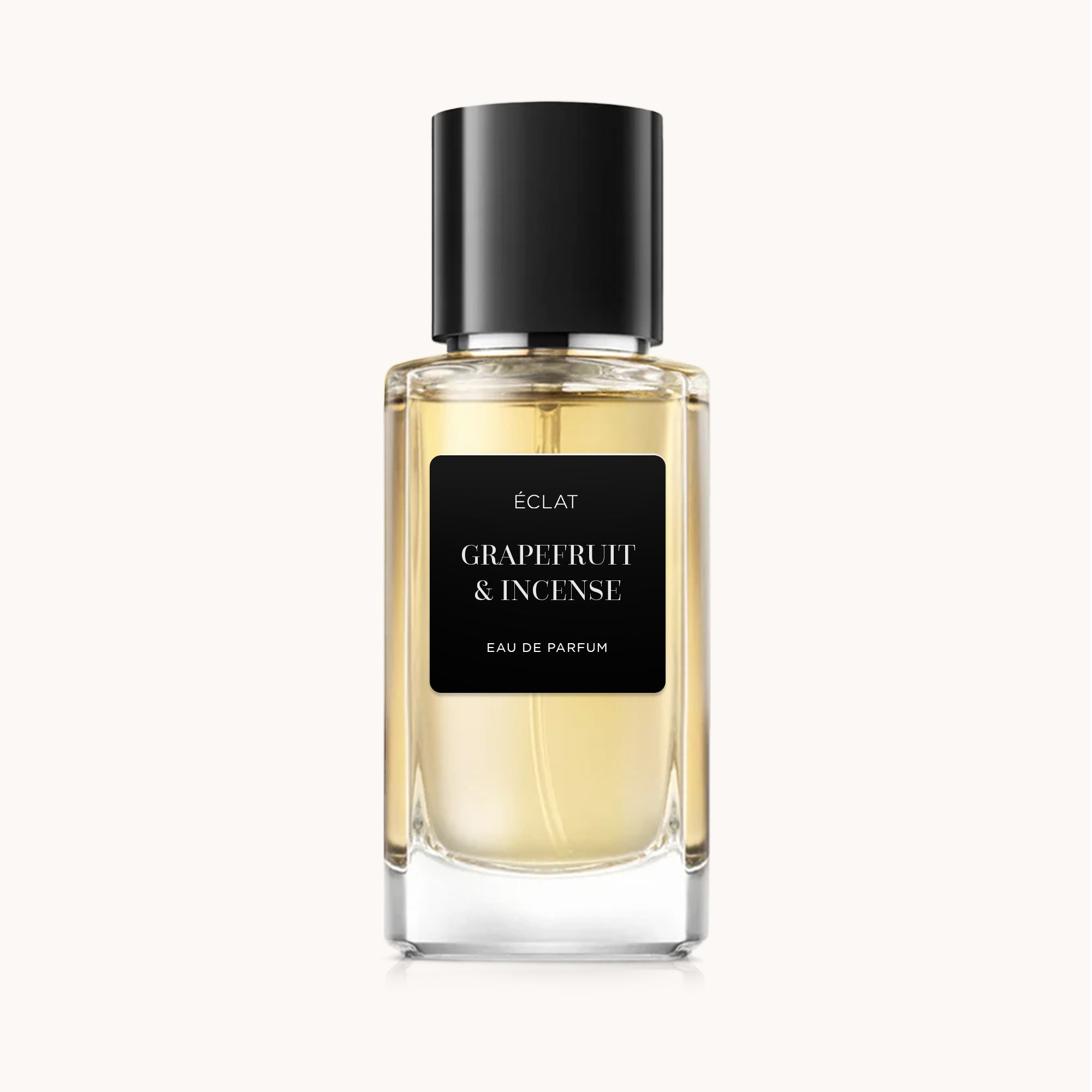 Faceted glass bottle with a black cap and a matte label, displaying ÉCLAT Grapefruit & Incense.