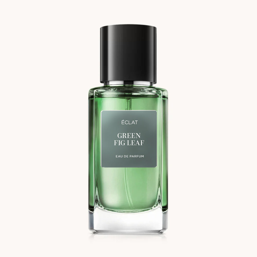 Faceted glass bottle of ÉCLAT Green Fig Leaf with a green hue and a sleek black cap.