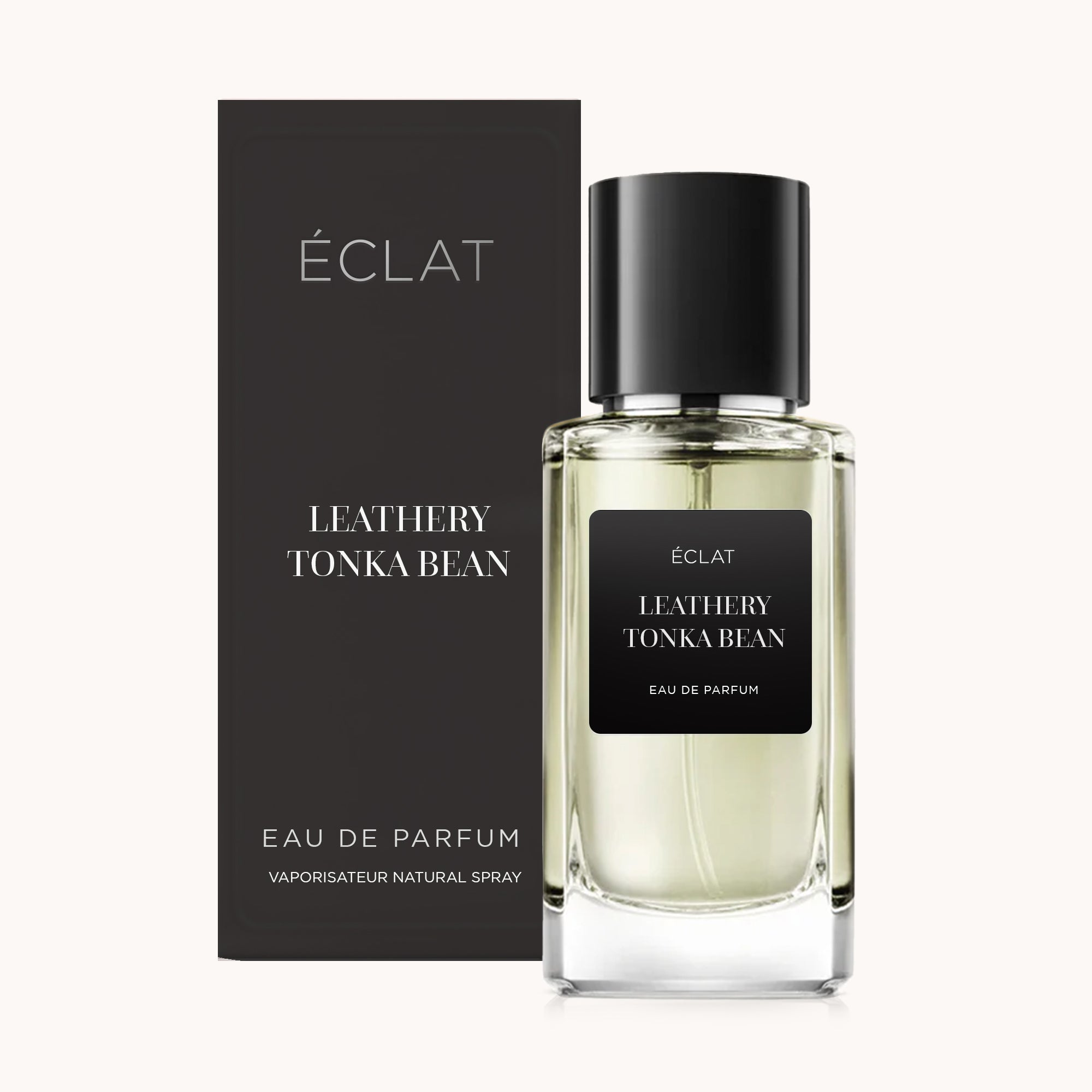 The ÉCLAT Leathery Tonka Bean fragrance features a clear glass bottle with a black label and cap, accompanied by a matching black box.