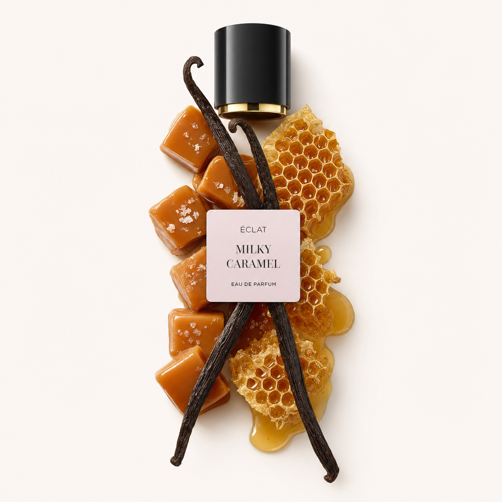 An arrangement of caramel cubes, vanilla pods, and honeycomb beneath a black cap with a pink label reading ÉCLAT Milky Caramel.