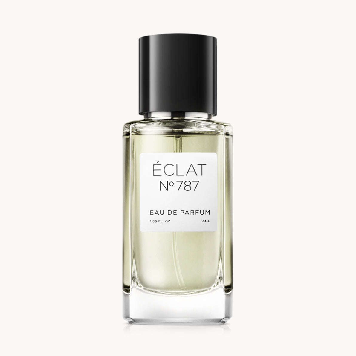 A fragrância ÉCLAT Mint & Spices é apresentada num frasco de vidro transparente com uma tampa preta elegante e uma etiqueta branca minimalista.
