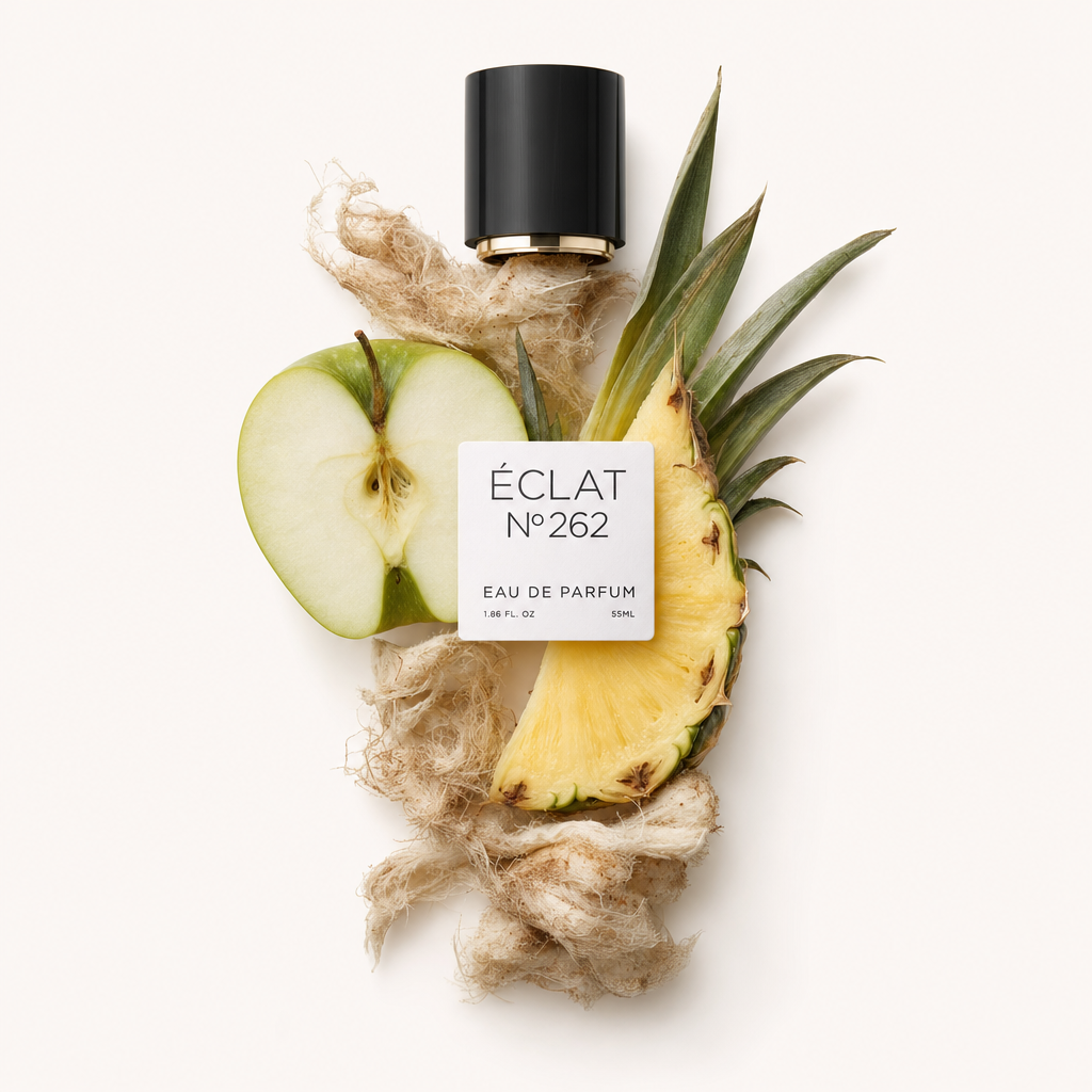 An arrangement of fresh apple and pineapple slices on a bed of fibrous material, with the original ÉCLAT cap and label atop.