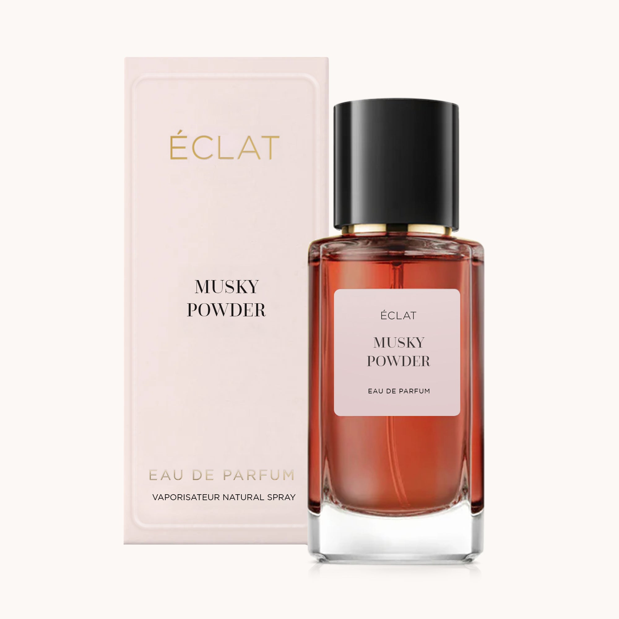 Faceted glass bottle of ÉCLAT Musky Powder with a black cap, next to its elegant beige packaging.