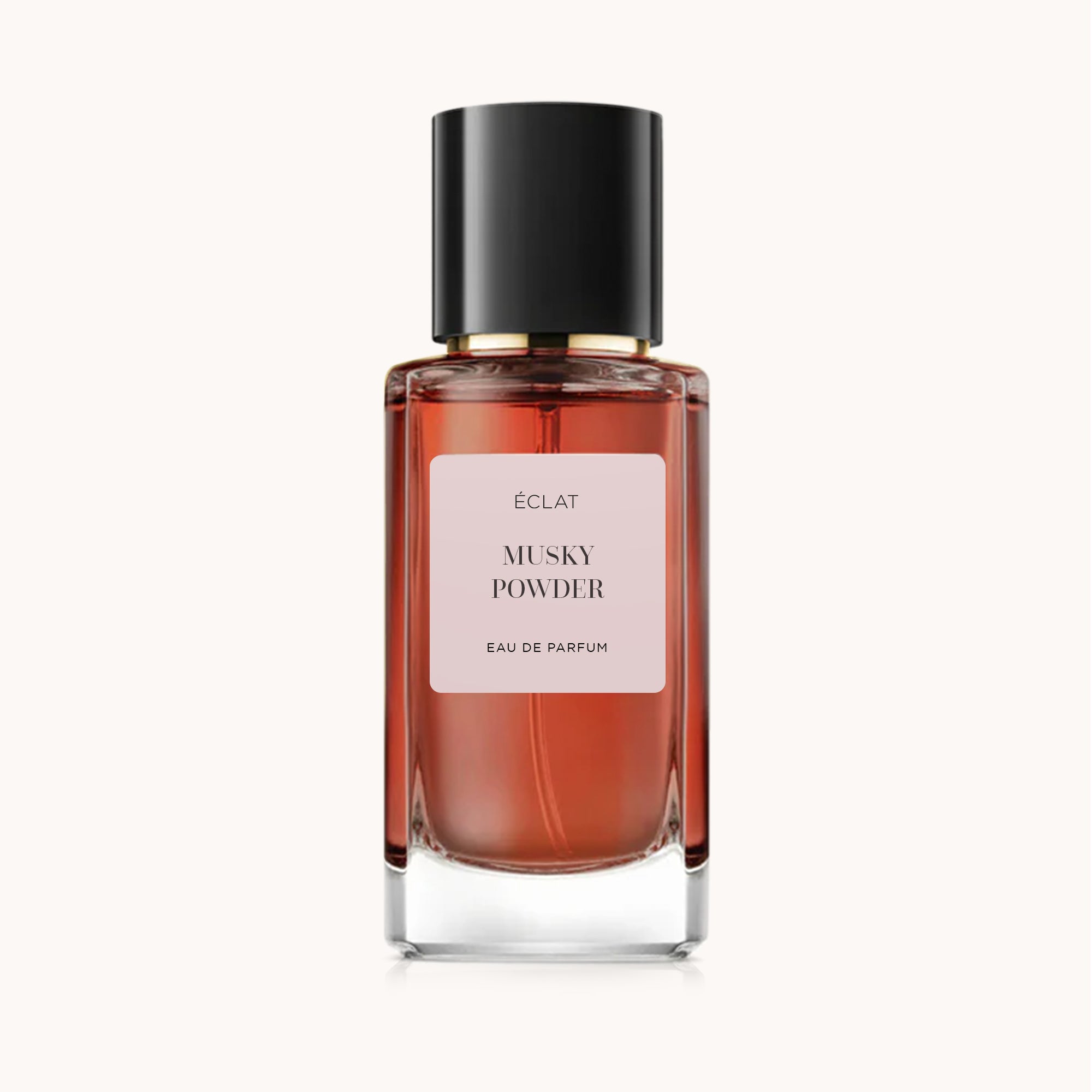 Faceted glass bottle of ÉCLAT Musky Powder with a black cap and pink label.
