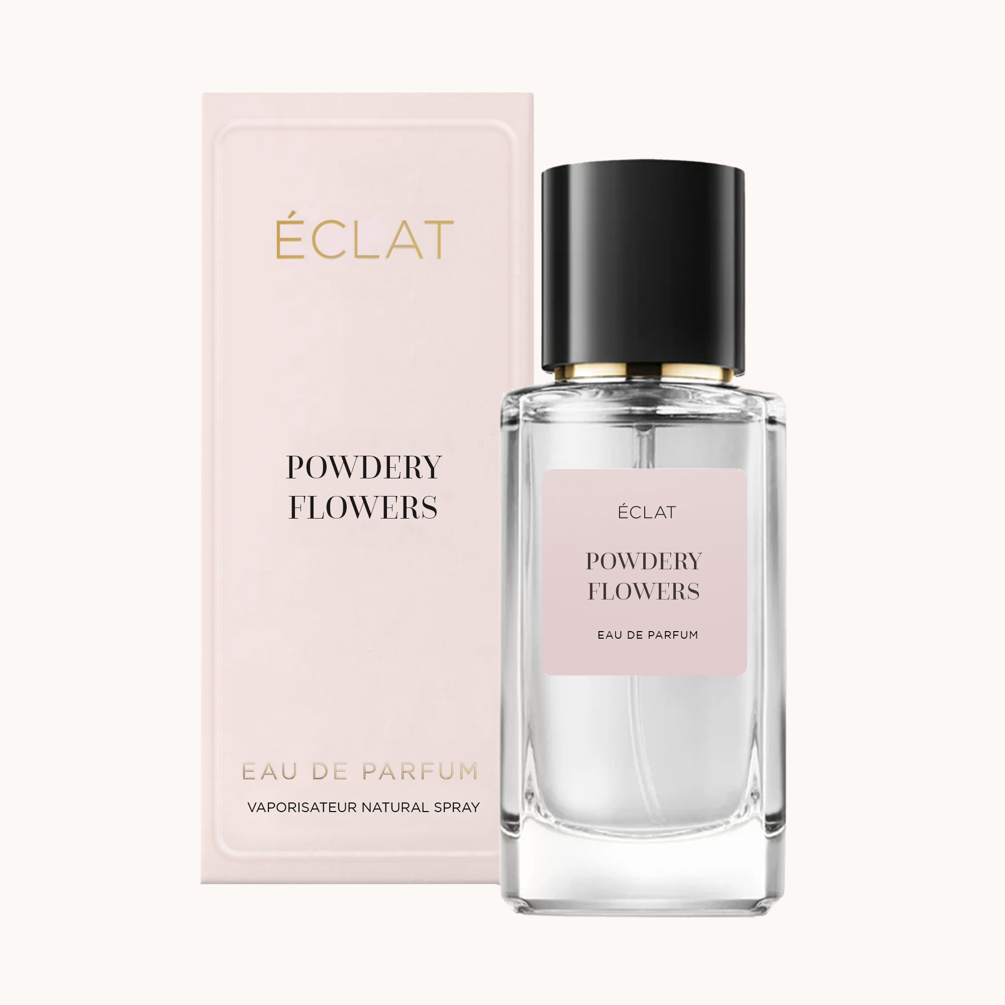 Faceted glass bottle of ÉCLAT Powdery Flowers with a black cap, placed next to a pale pink packaging box.