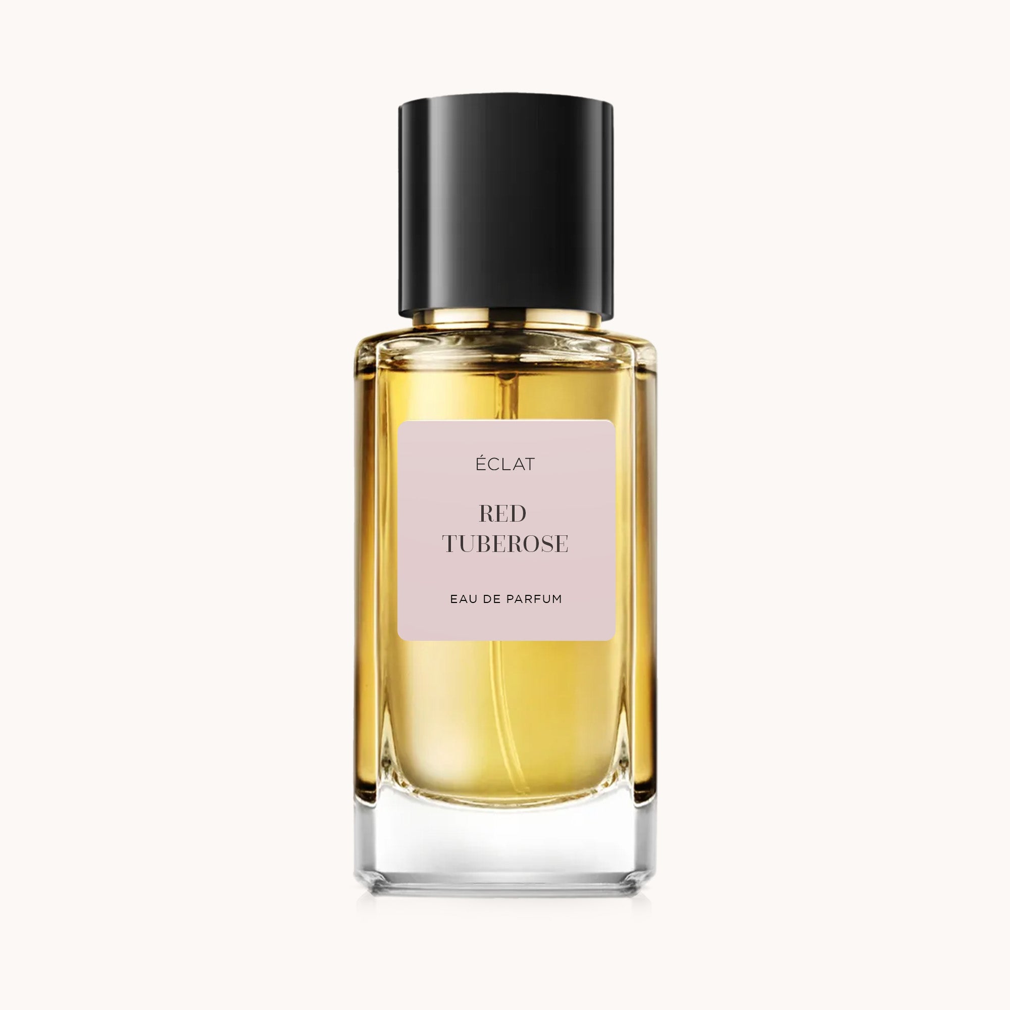 ÉCLAT Red Tuberose in a faceted glass bottle with a sleek black cap and a soft pink label.