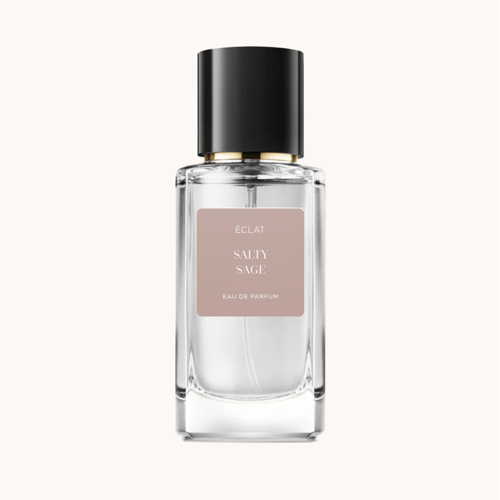 A clear faceted glass bottle of ÉCLAT Salty Sage perfume with a black cap and a beige label.