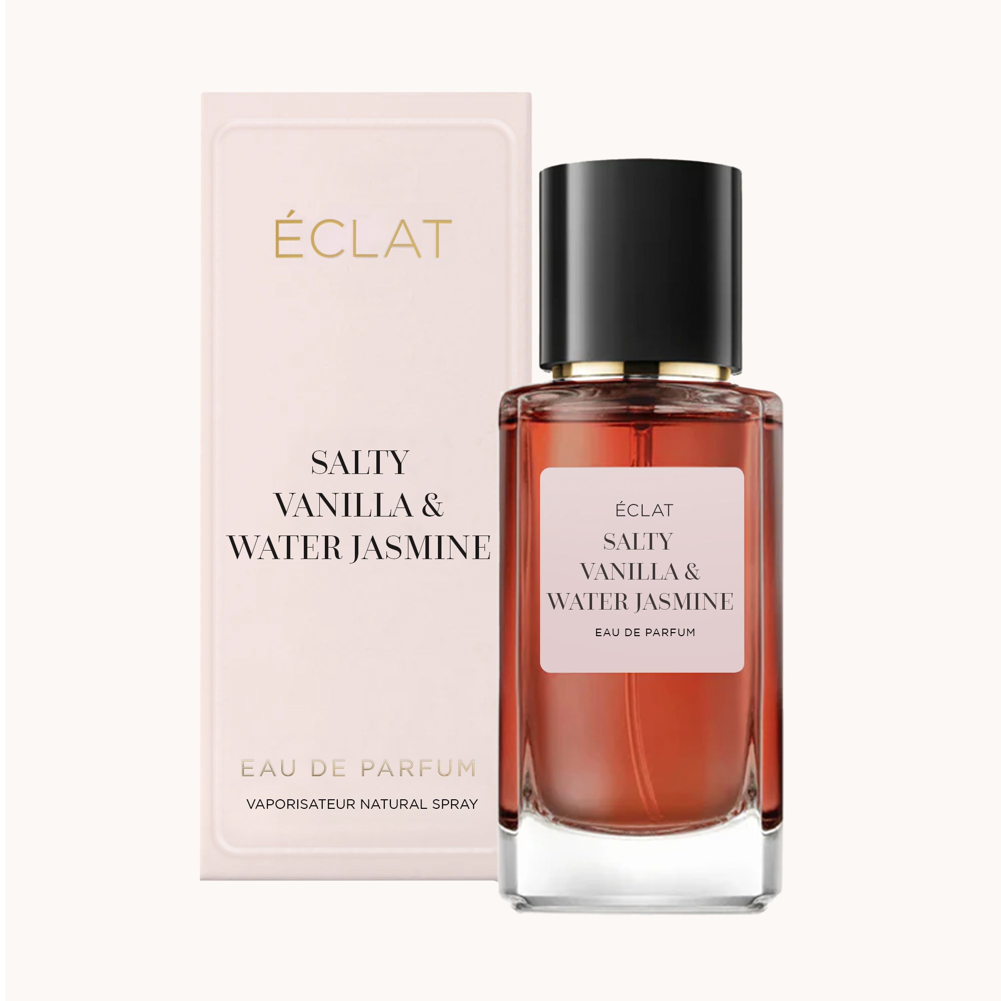 Άρωμα ÉCLAT Salty Vanilla & Water Jasmine με γυάλινο μπουκάλι κεχριμπαρένιου τόνου και μαύρο καπάκι, συνοδευόμενο από ένα απαλό κουτί.