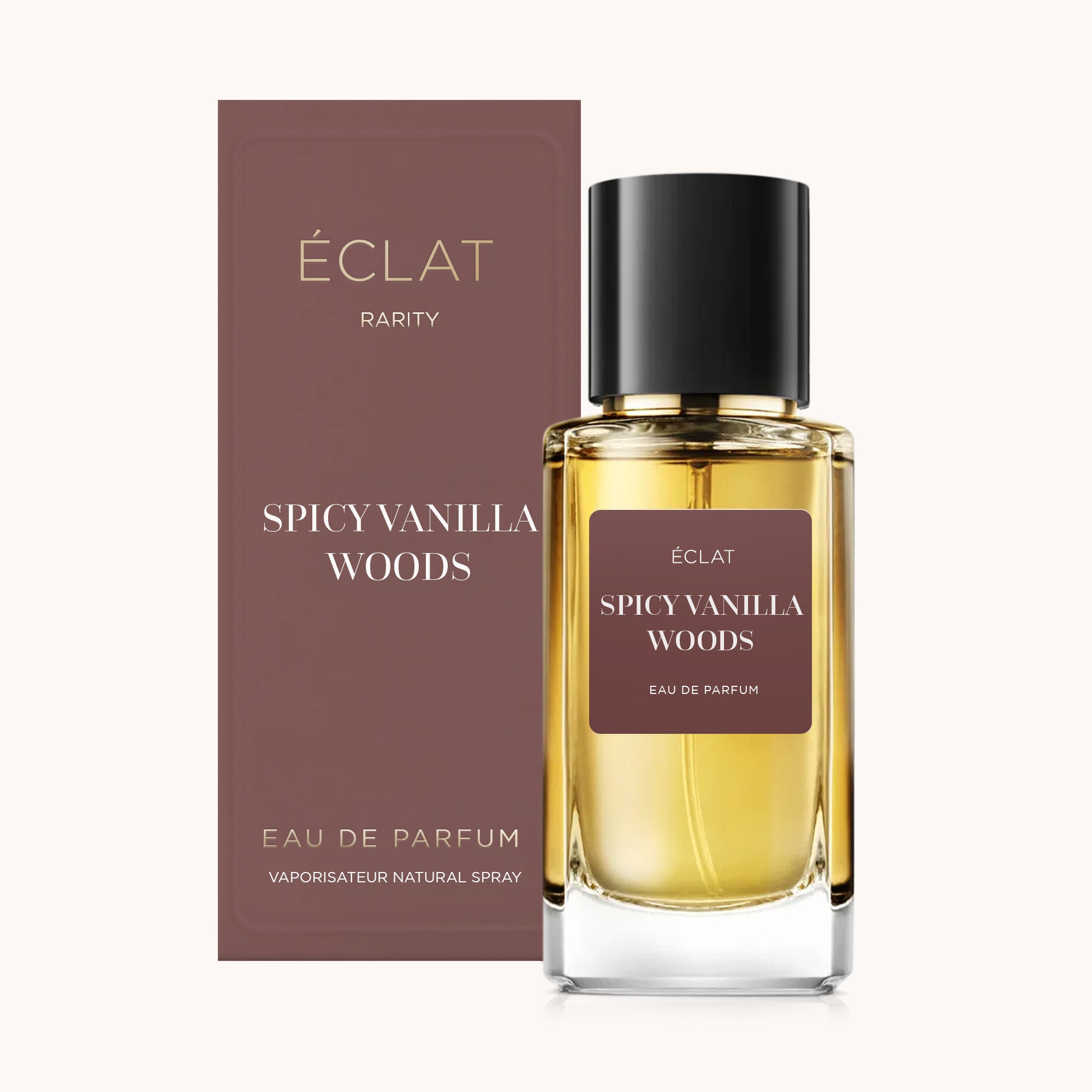 Flacon en verre facetté d'ÉCLAT Spicy Vanilla Woods avec un bouchon noir, à côté d'une boîte marron assortie.