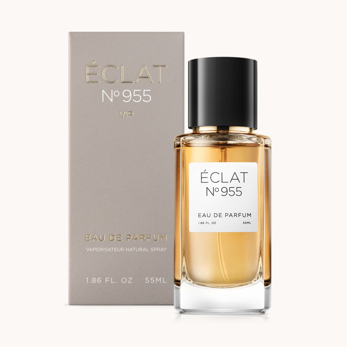 A fragrância ÉCLAT VIP Suede & Vanilla num frasco de vidro transparente com tampa preta, acompanhada da sua elegante embalagem cinza.