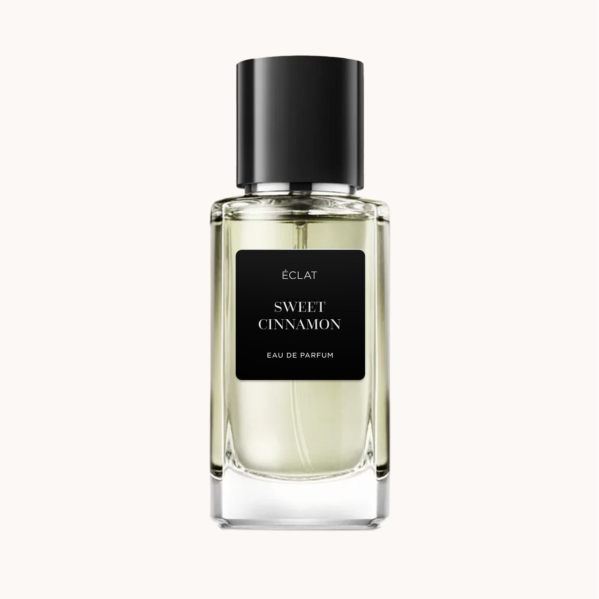 ÉCLAT Sweet Cinnamon fragrance in a clear glass bottle with a black cap and label.