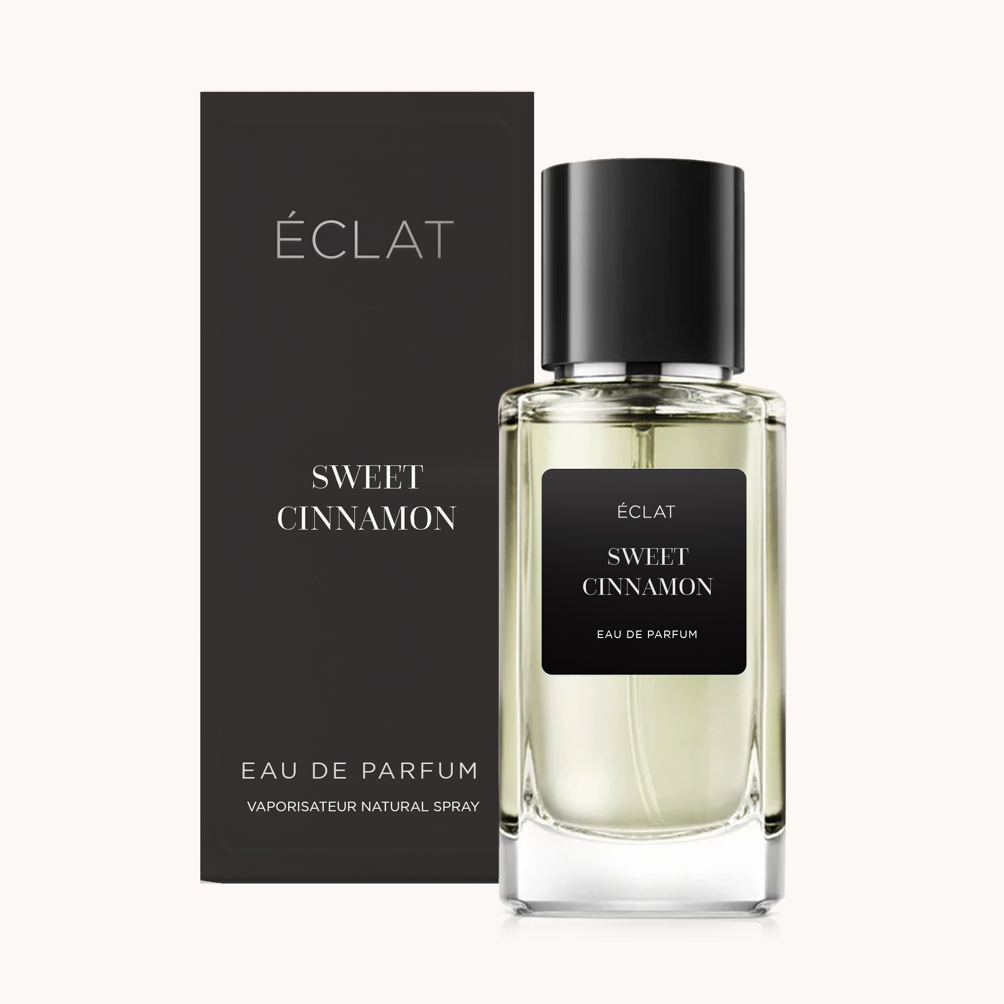 Glass flacon of ÉCLAT Sweet Cinnamon with black label and matching black box in the background.