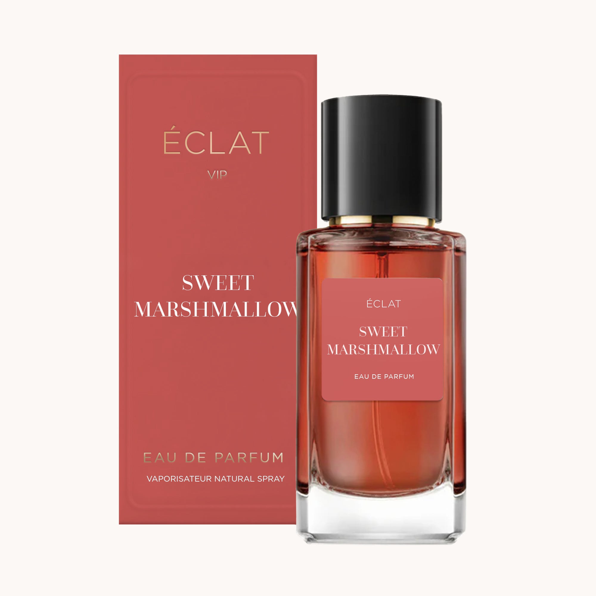 Flacon de parfum ÉCLAT Sweet Marshmallow en verre transparent avec un capuchon noir, à côté de sa boîte rose assortie.